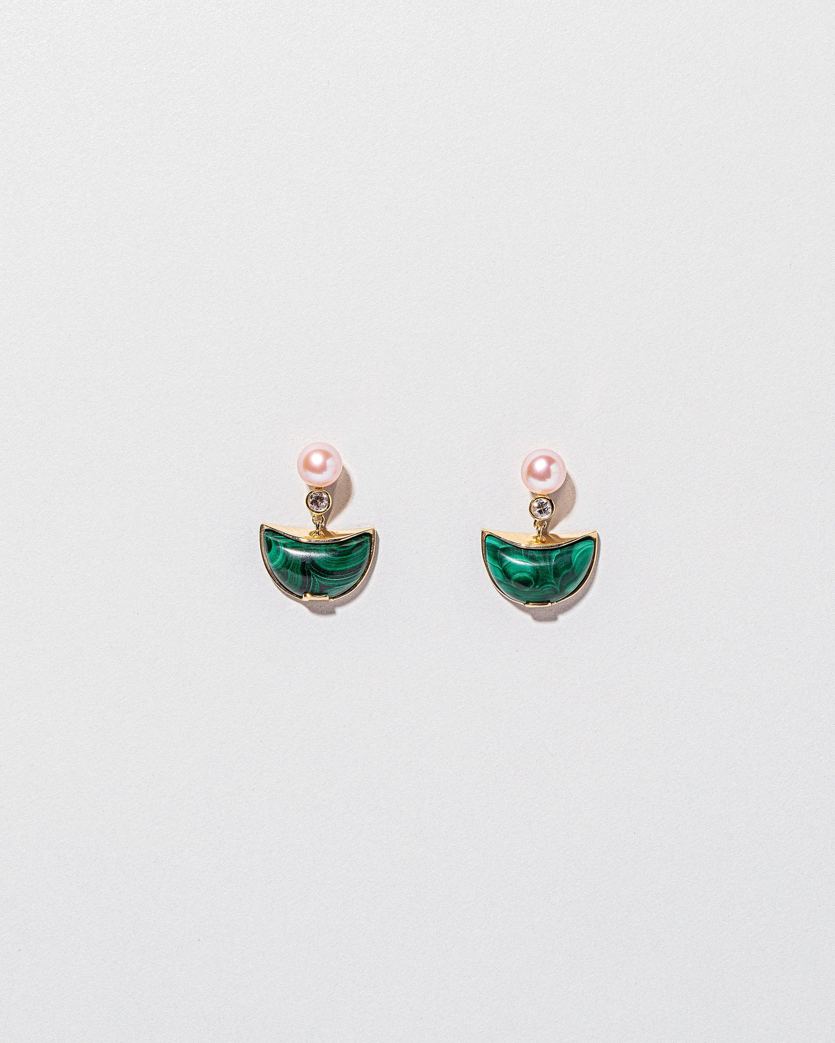  Guidance Earrings on light color background.