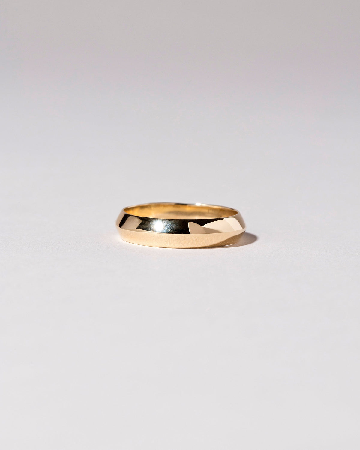 Gold 5mm Knife Edge Band on light color background.