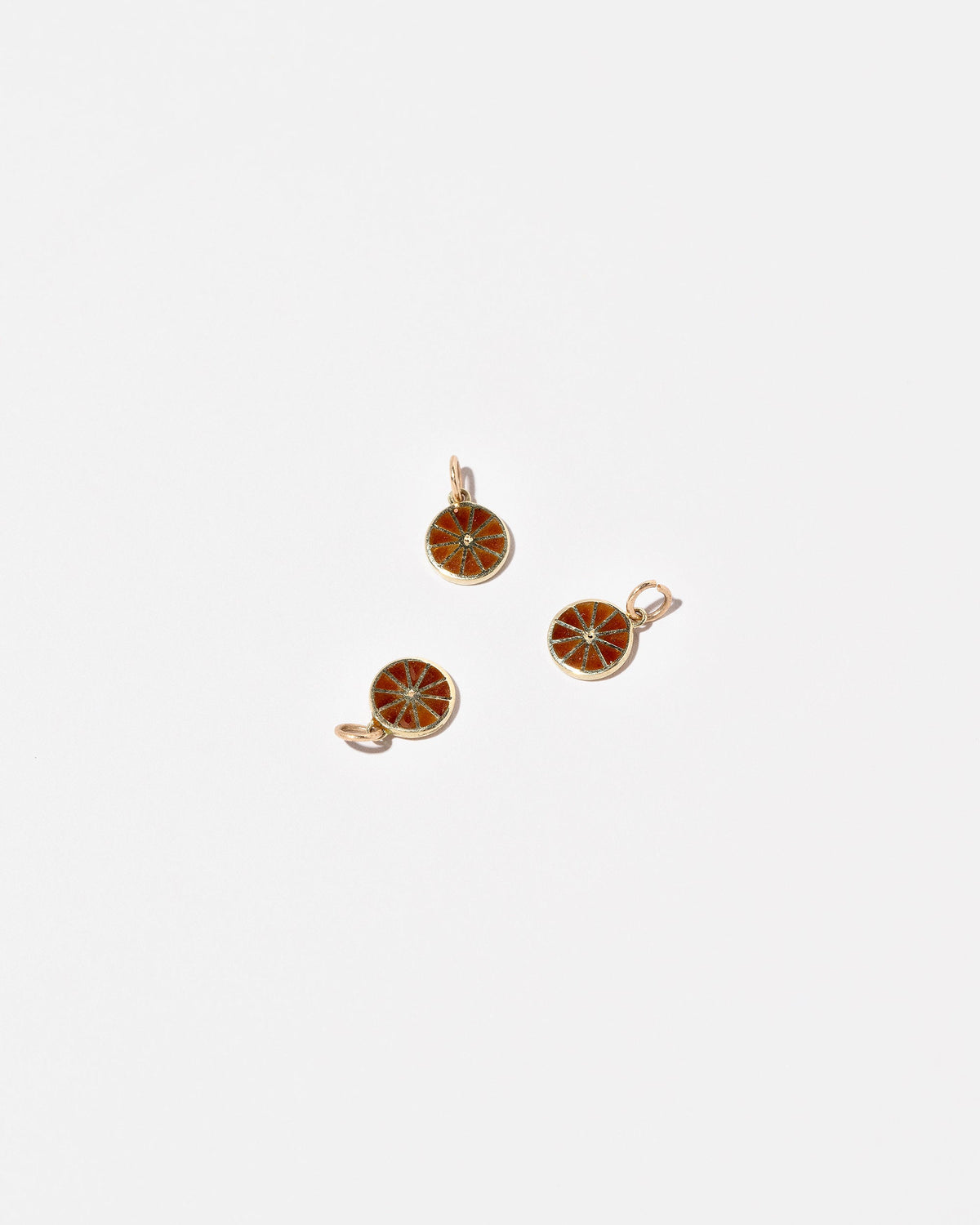 Orange Slice Charms on light color background.