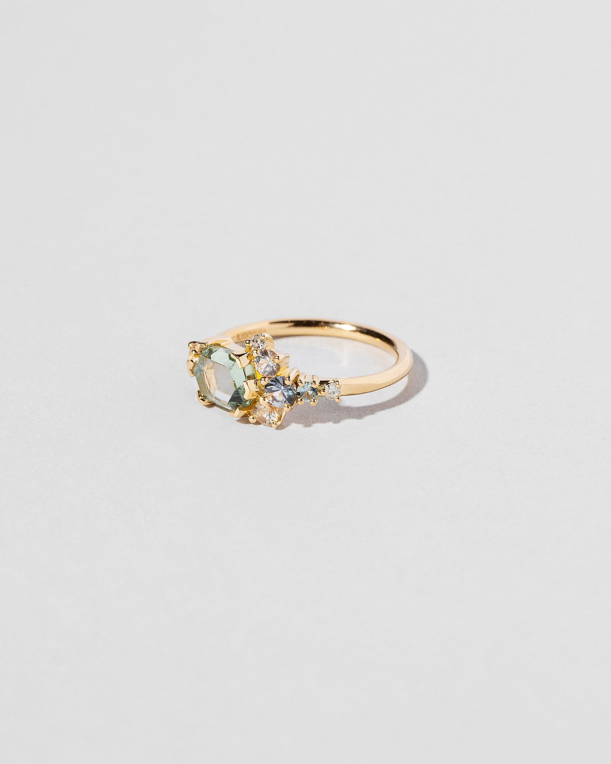  Hexagonal Slice Sapphire Cluster Ring on light color background.