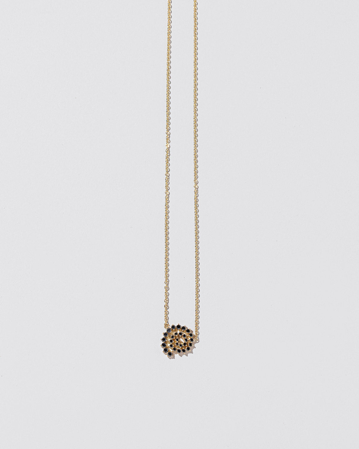 Full Black Diamond Spiral Necklace on light color background.
