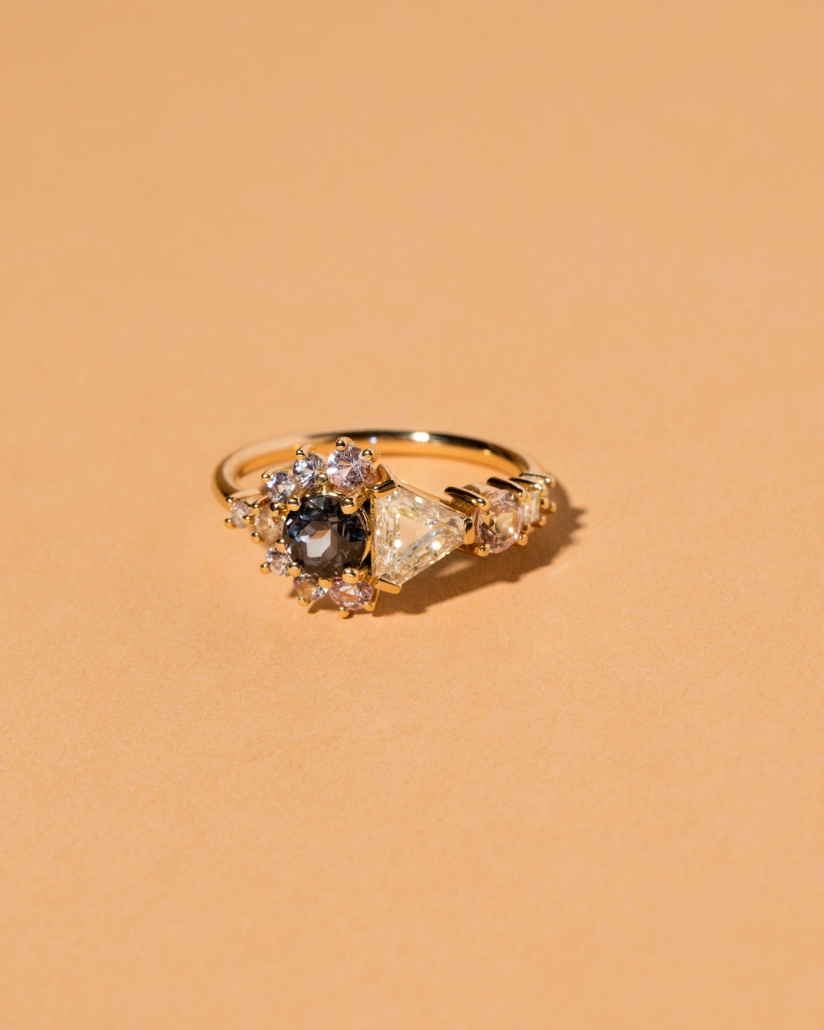  Diamond, Spinel & Sapphire Cluster Ring on light color background.