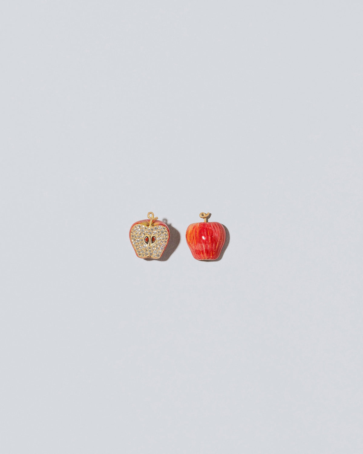 View from the front and view from the back of the Red Apple Core Charm on light color background. Charm sold individually,