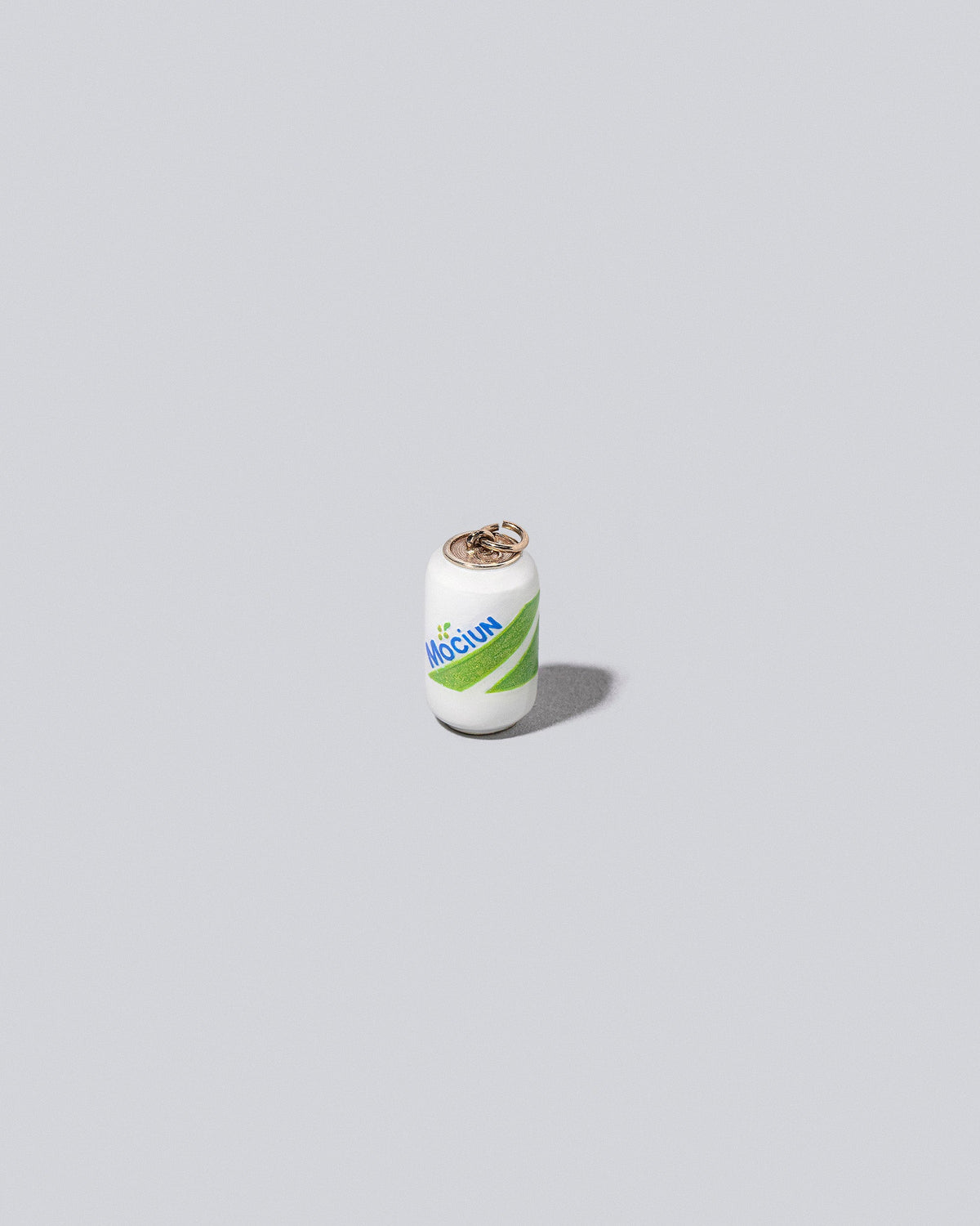 Mociun Soda Charm on light color background.