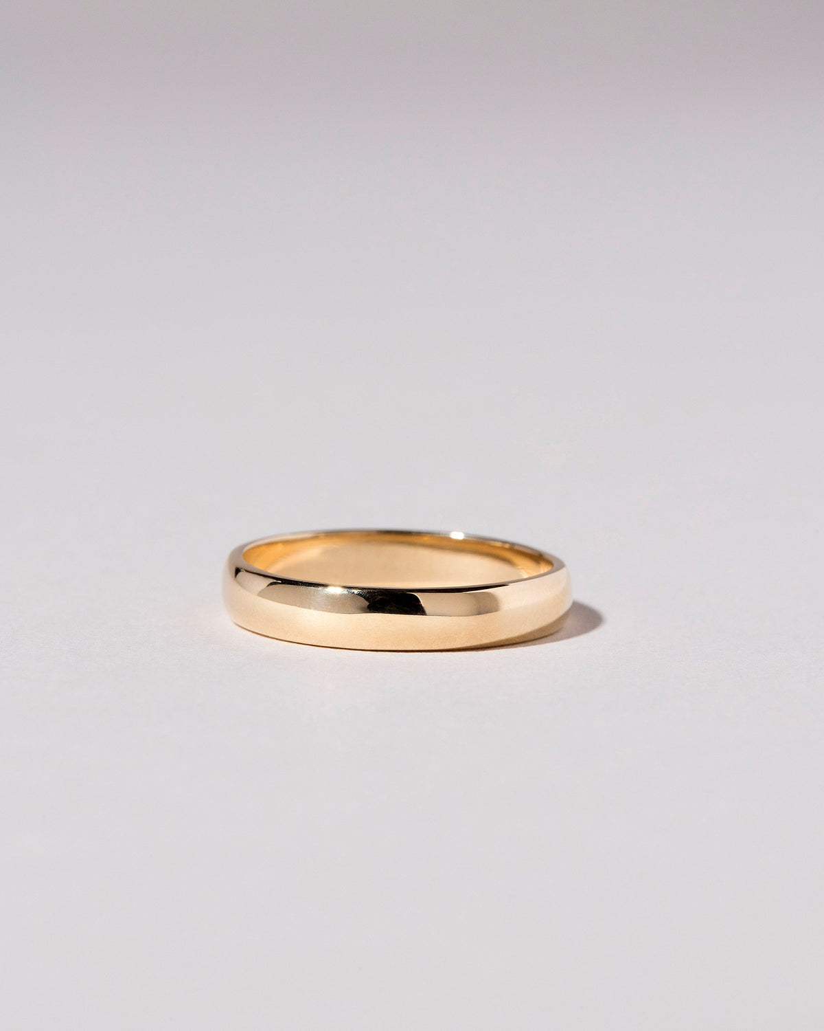 Gold 4mm Half Round Band on light color background.