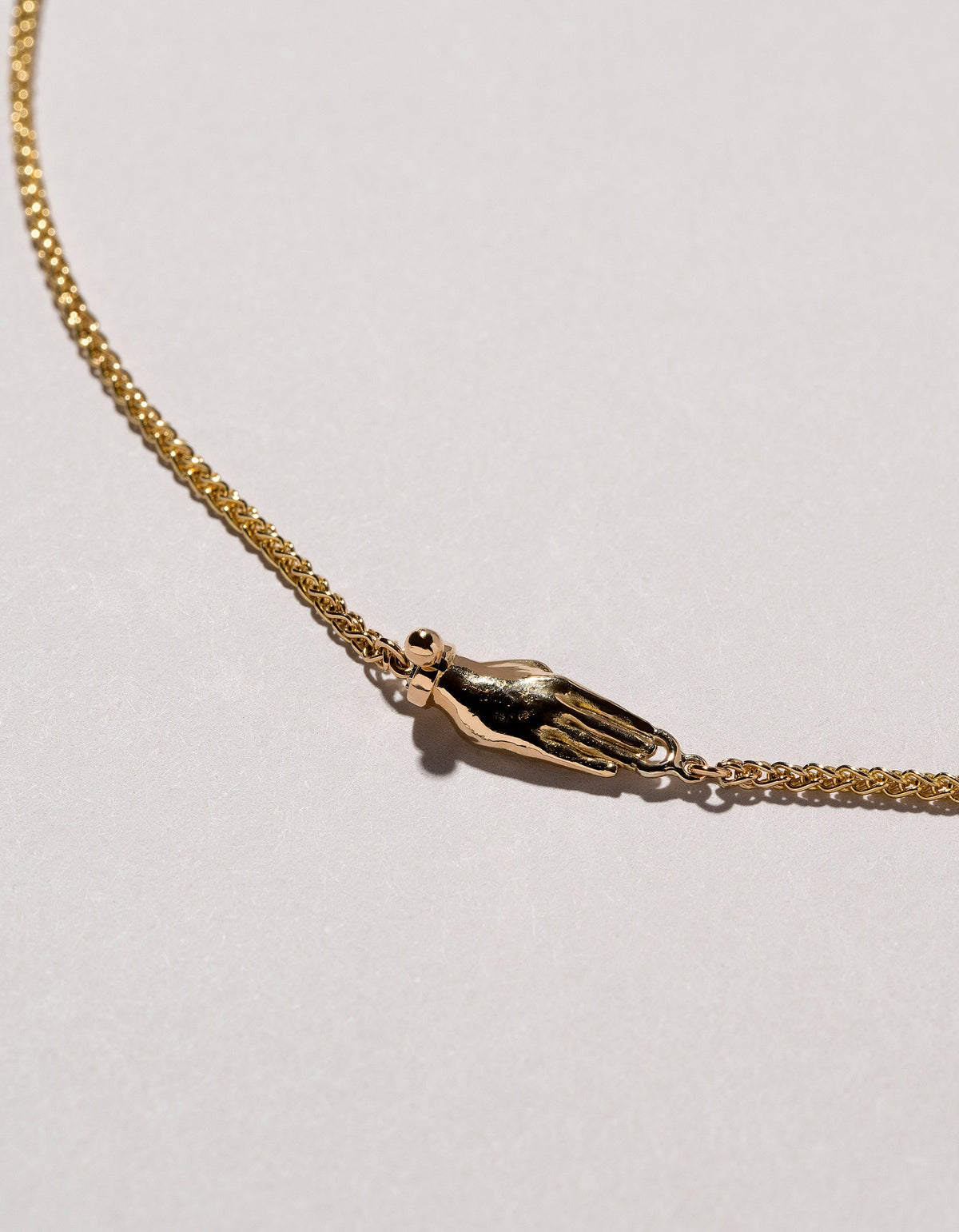 Manifestation Necklace on light color background.