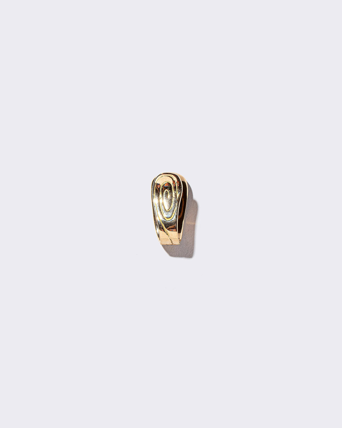 Solid Duality Hoop Earring on light color background.
