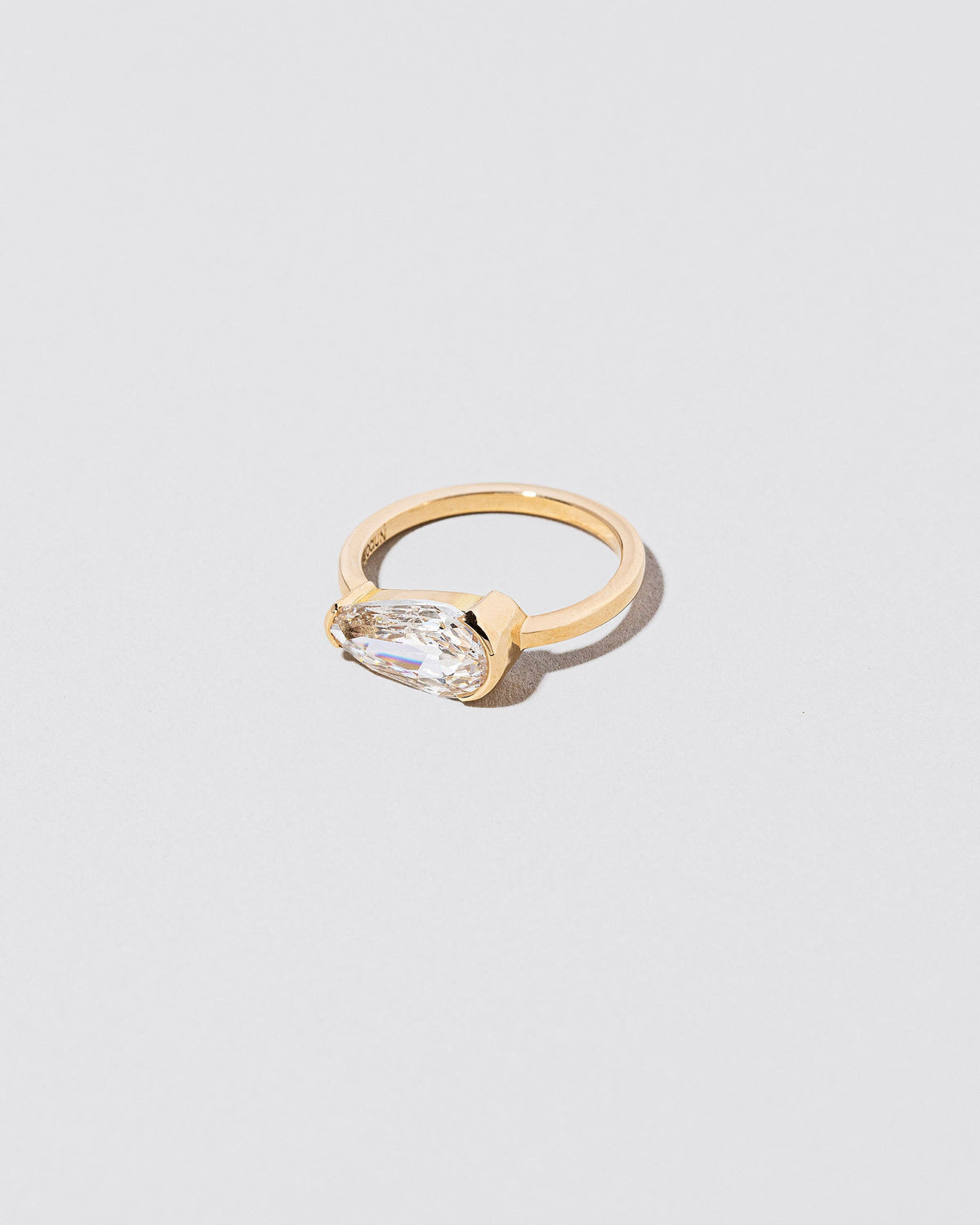 View from the side of the Divination Ring on light color background.