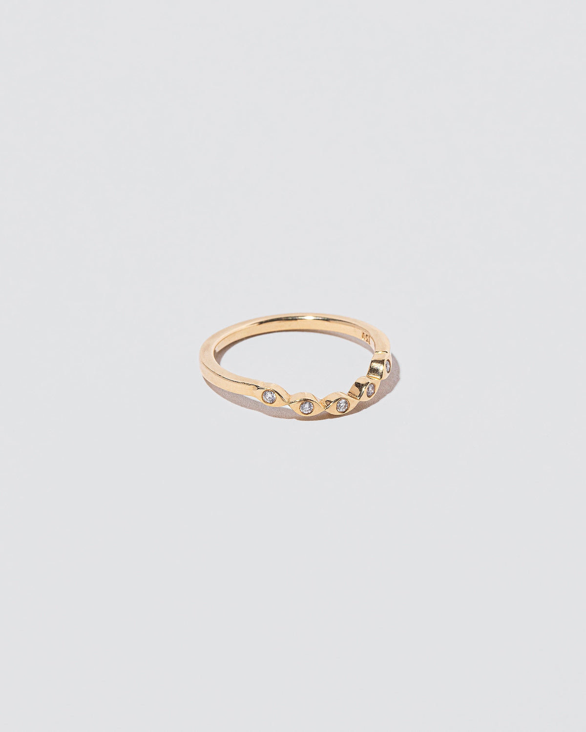 View from the side of the Gold Seeing Eye Band on light color background.