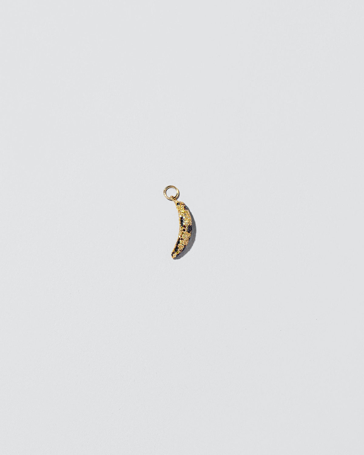 Bruised Banana Charm on light color background.