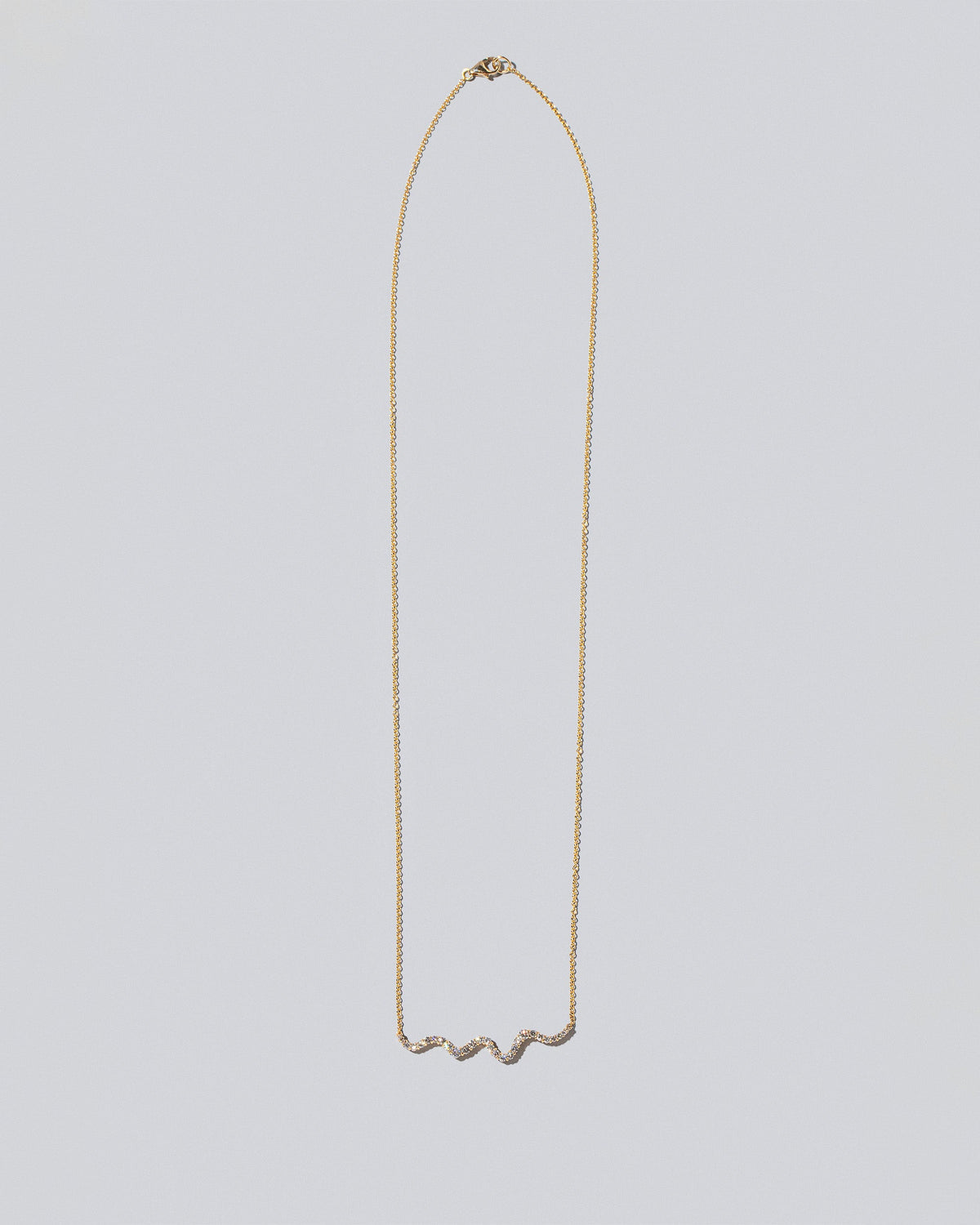 White Diamond Ripple Wave Necklace on light color background.