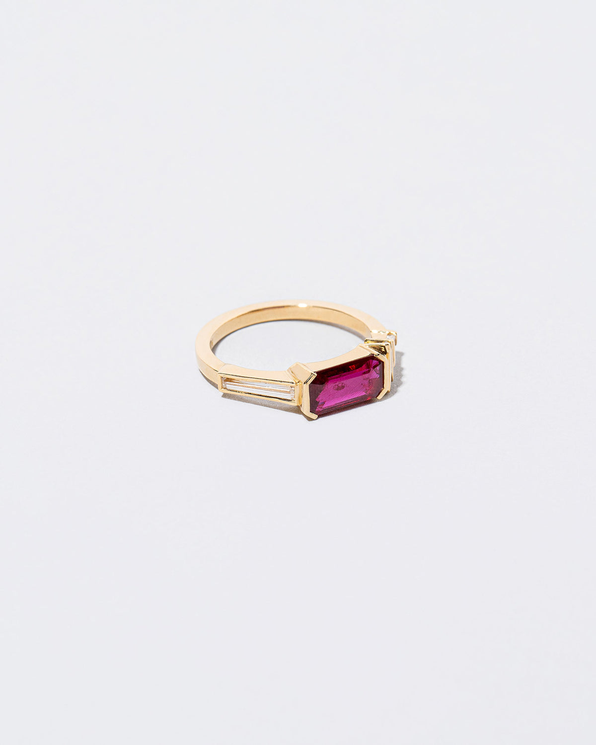 View from the side of the Femme Volage Ring on light color background.