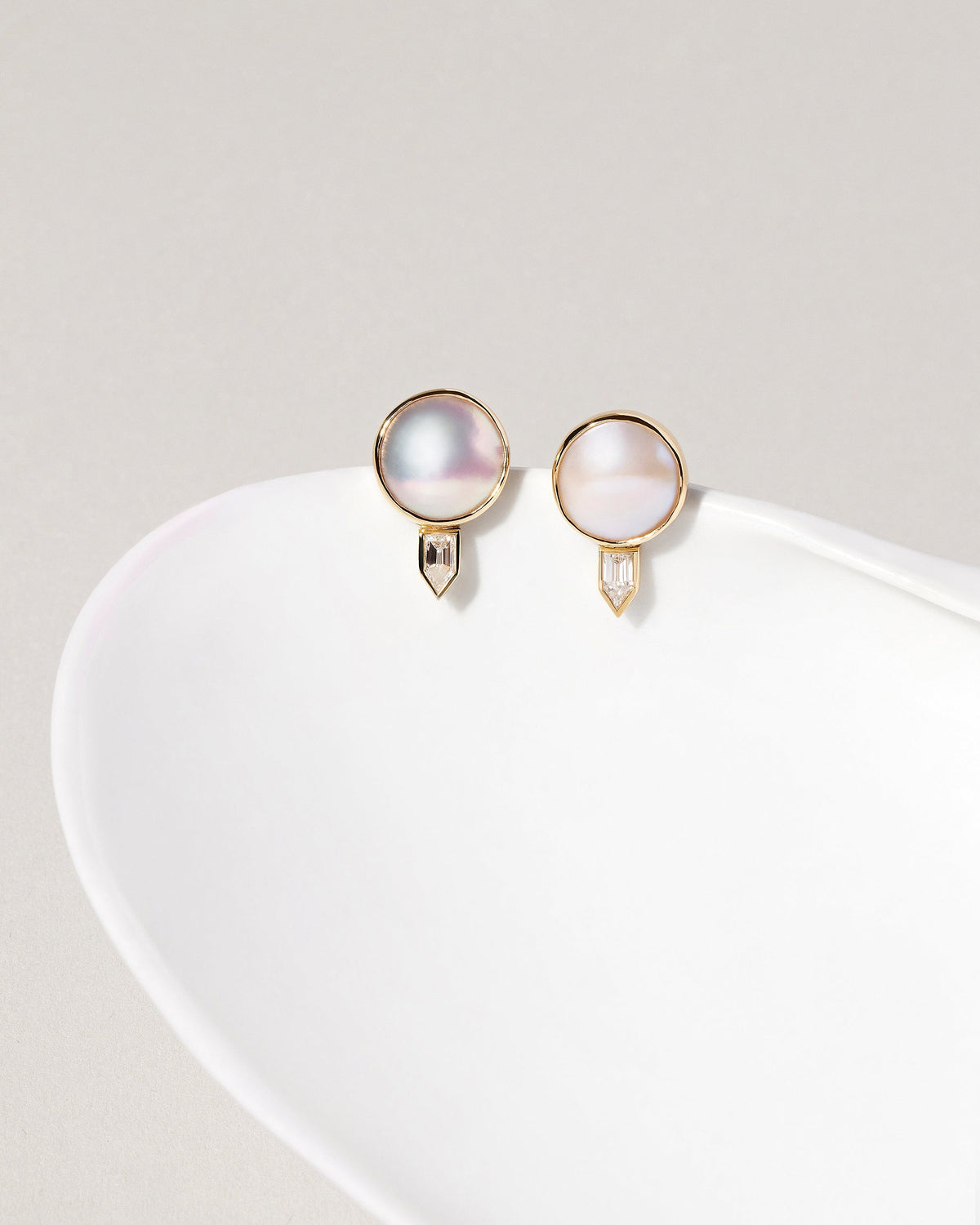  Mabe Pearl & Diamond Earrings on light color background.