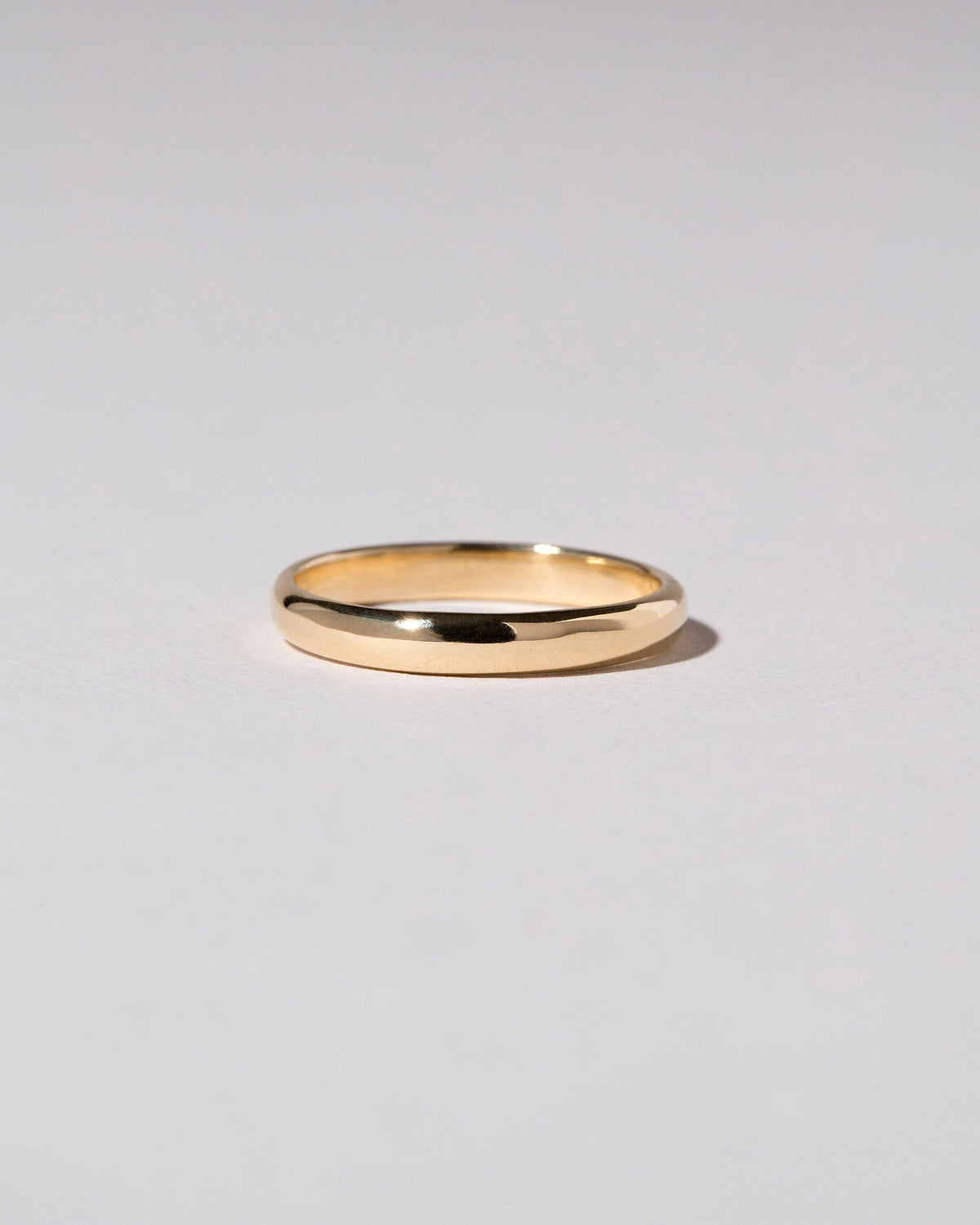 Gold 2mm Half Round Band on light color background.