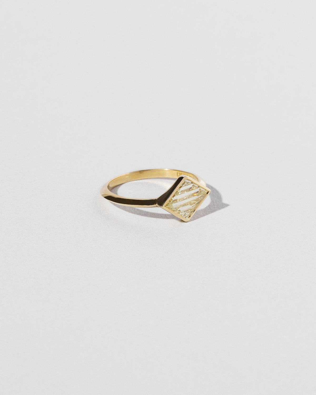 View from the side of the Aidos Ring on light color background.