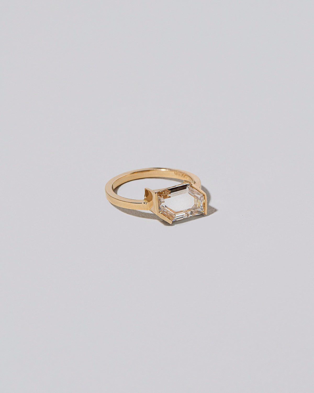 View from the side of the Heart & Soul Ring on light color background.