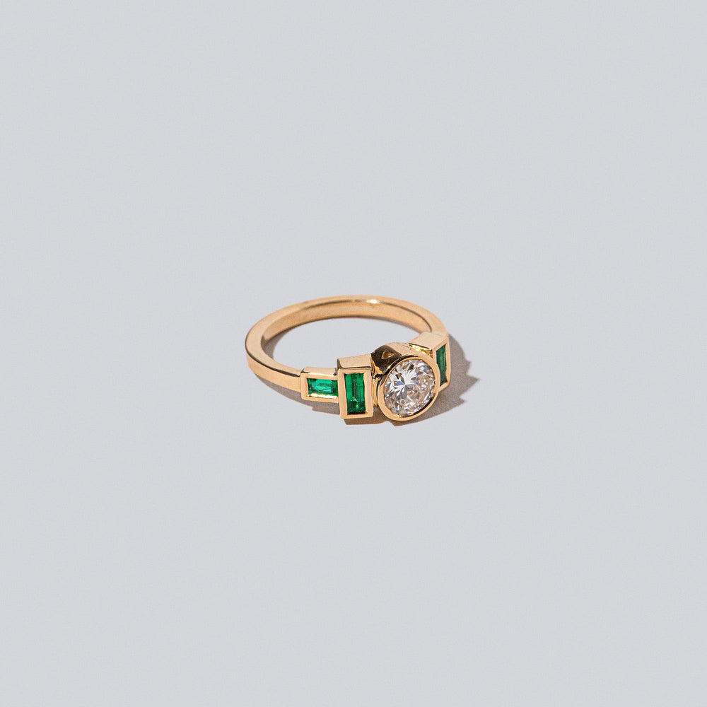 product_details::Diamond & Emerald Third Eye Ring on light colored background.