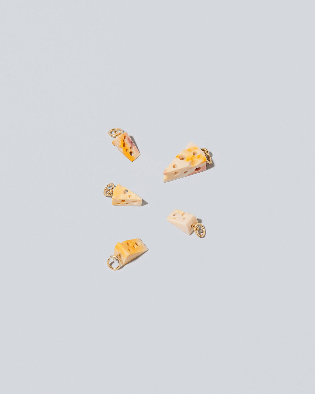 Swiss Cheese Charms on light color background.