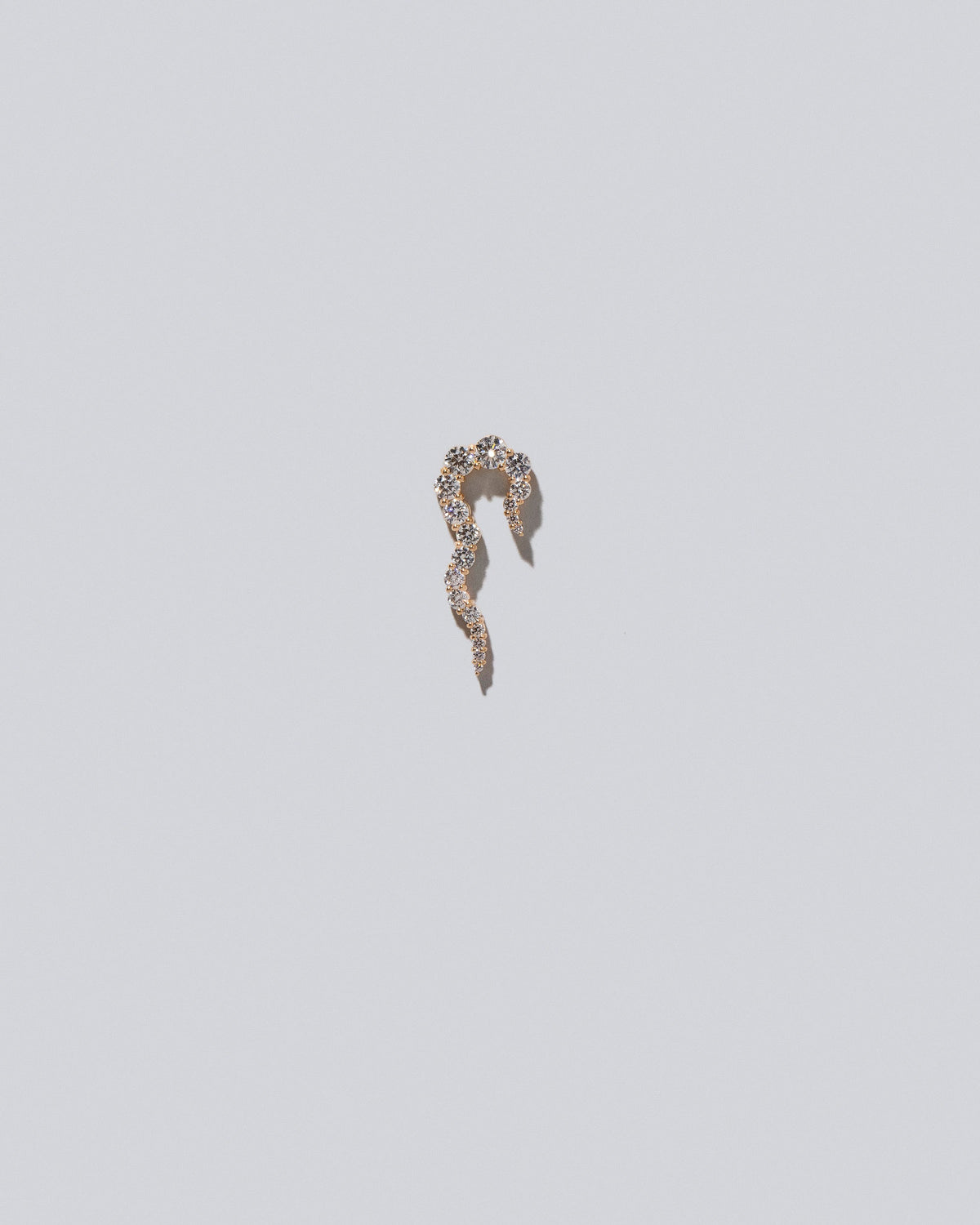 Gold White Diamond Right Tidal Wave Earring Single on light color background.