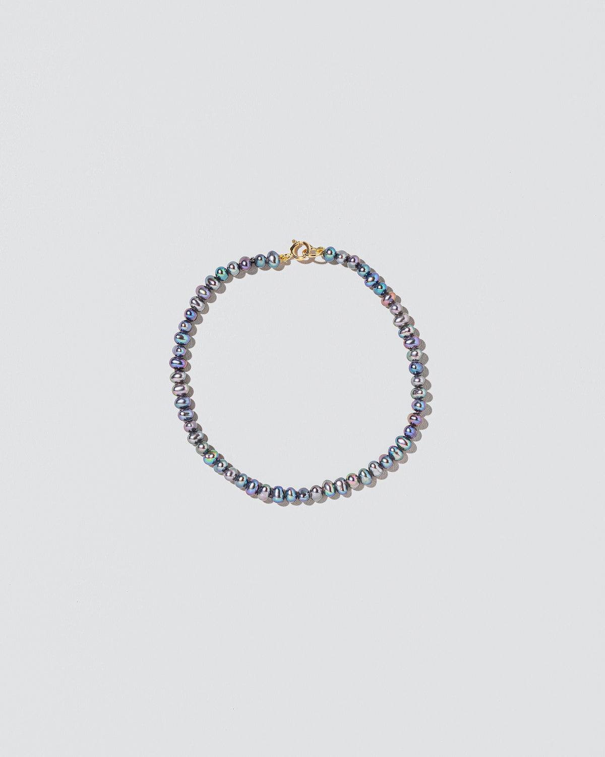 Peacock Seed Pearl Bracelet on light color background.