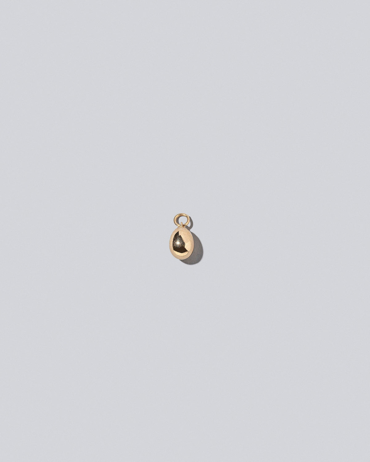 Egg Charm on light color background.