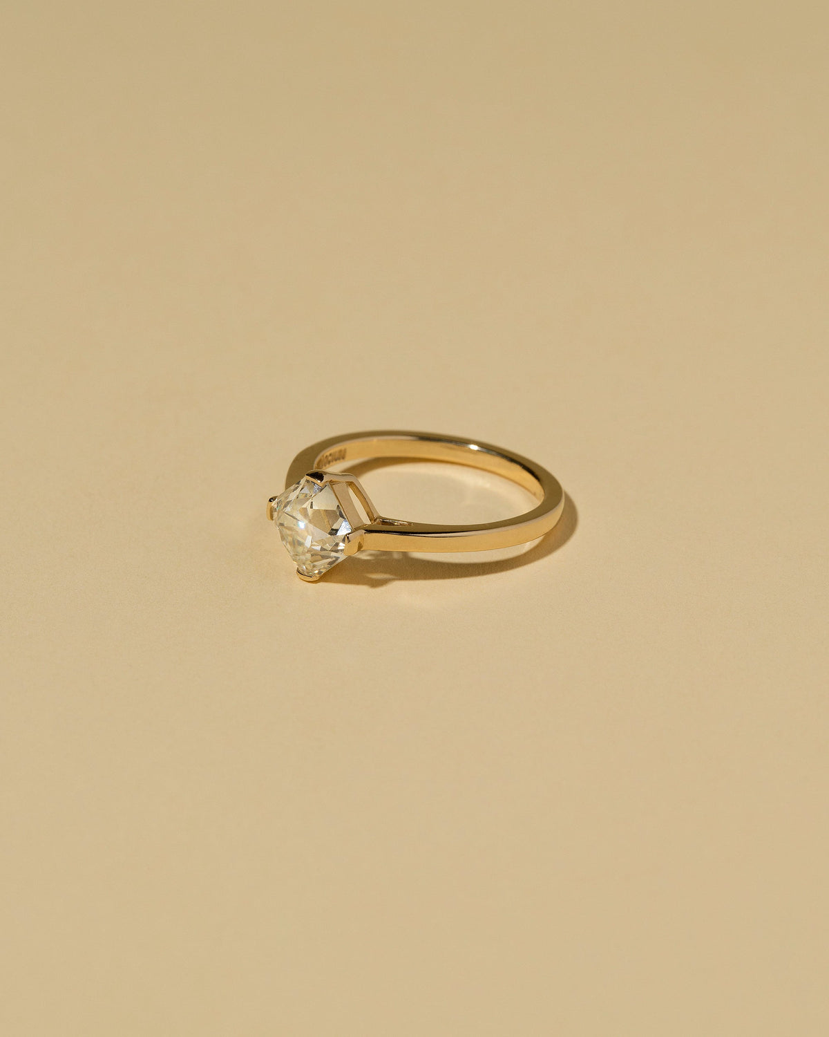 View from the side of the Cushion Modified Brilliant Diamond Solitaire Ring on light color background.