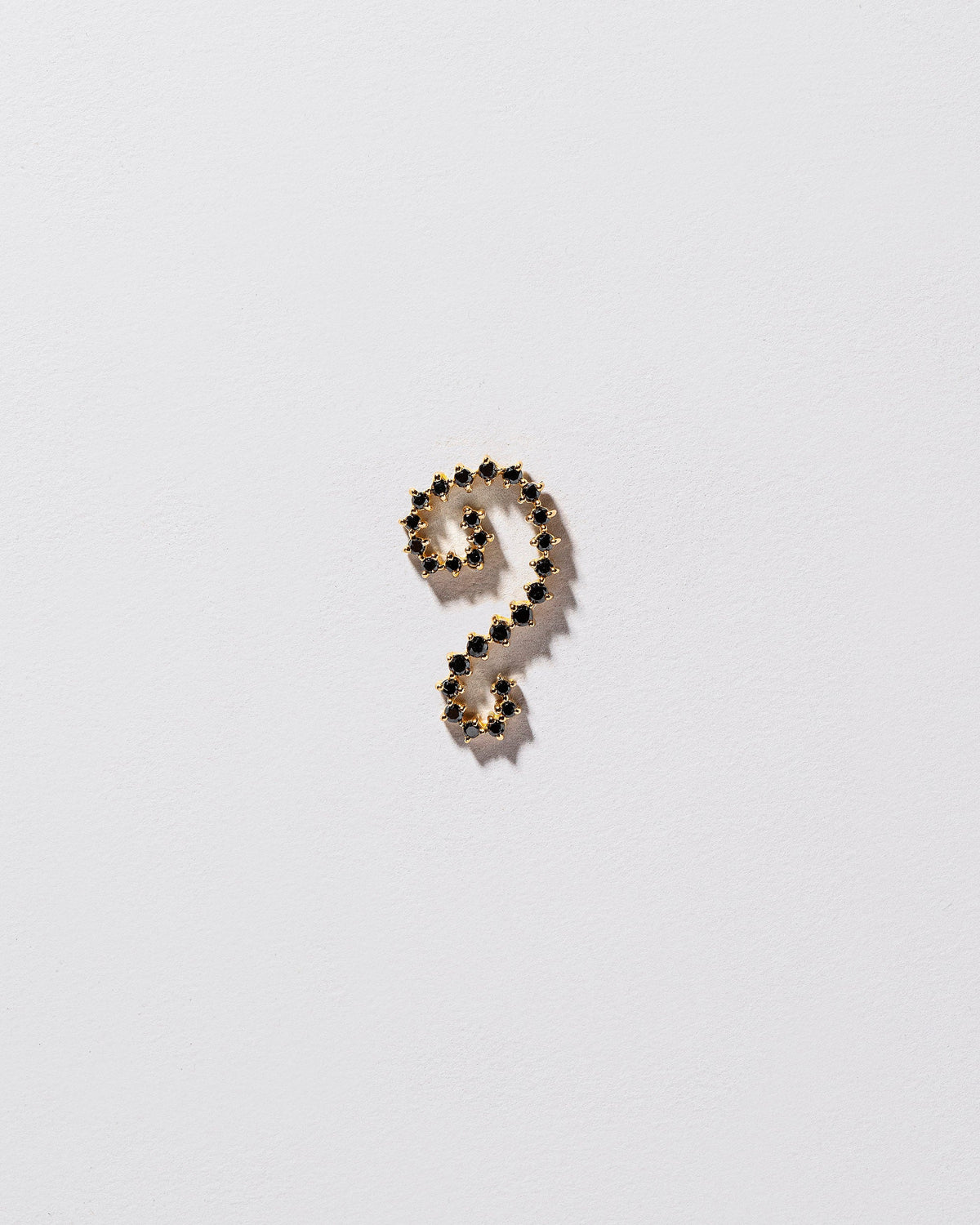 Left Black Diamond Symbol of Change Earring Single on light color background.