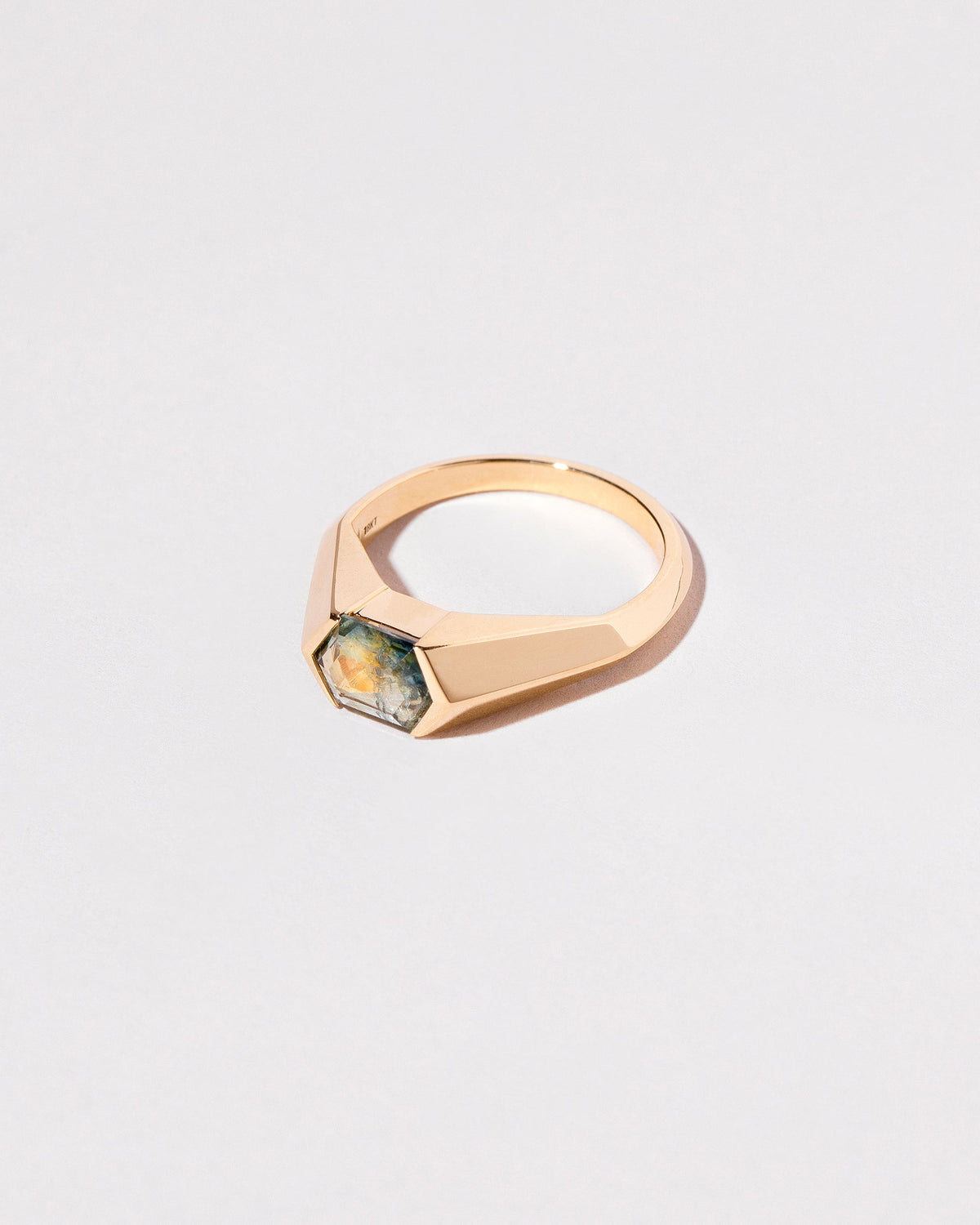 View from the side of the Caelum Ring on light color background.