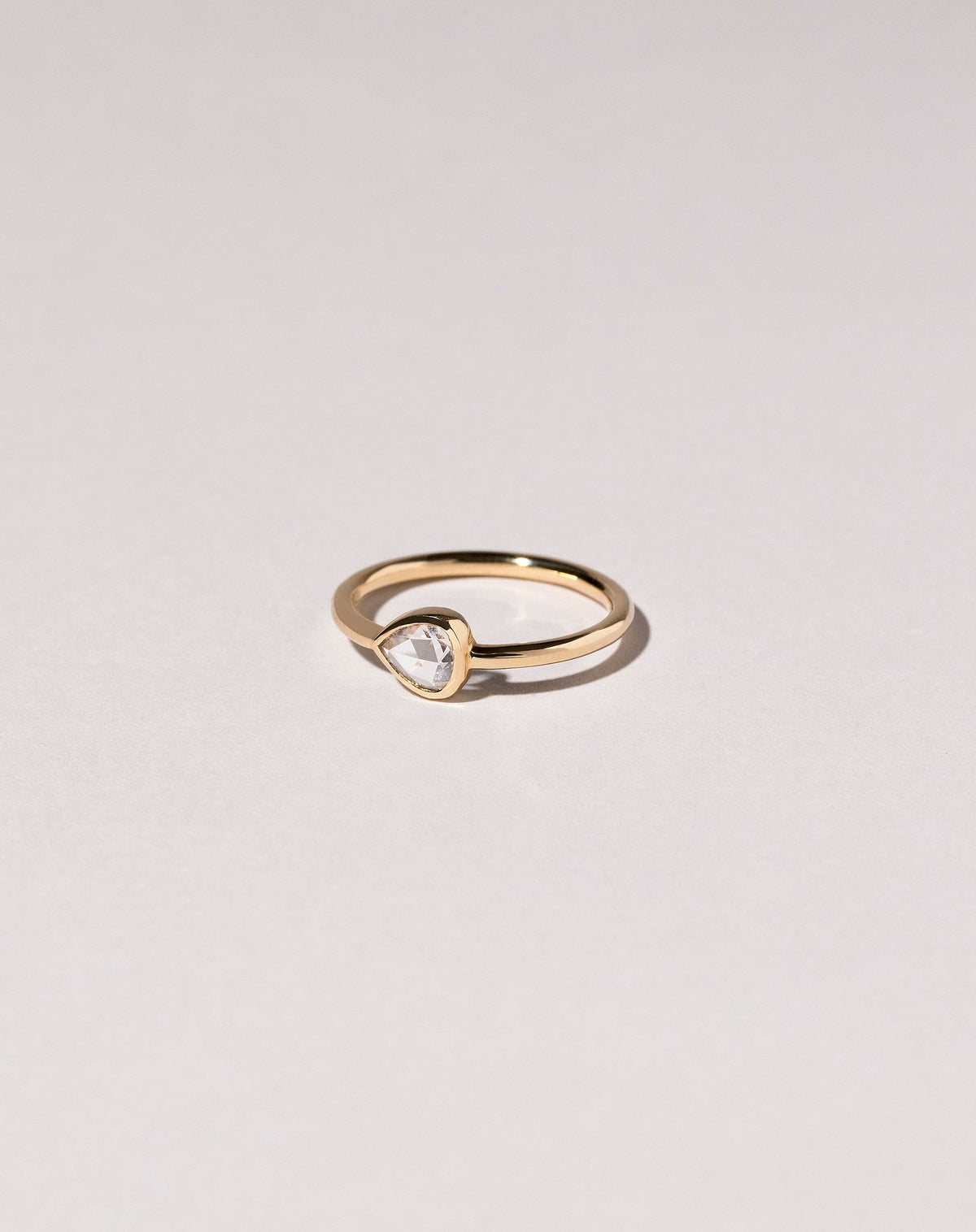 Rose Cut Pear Diamond Ring on light color background.