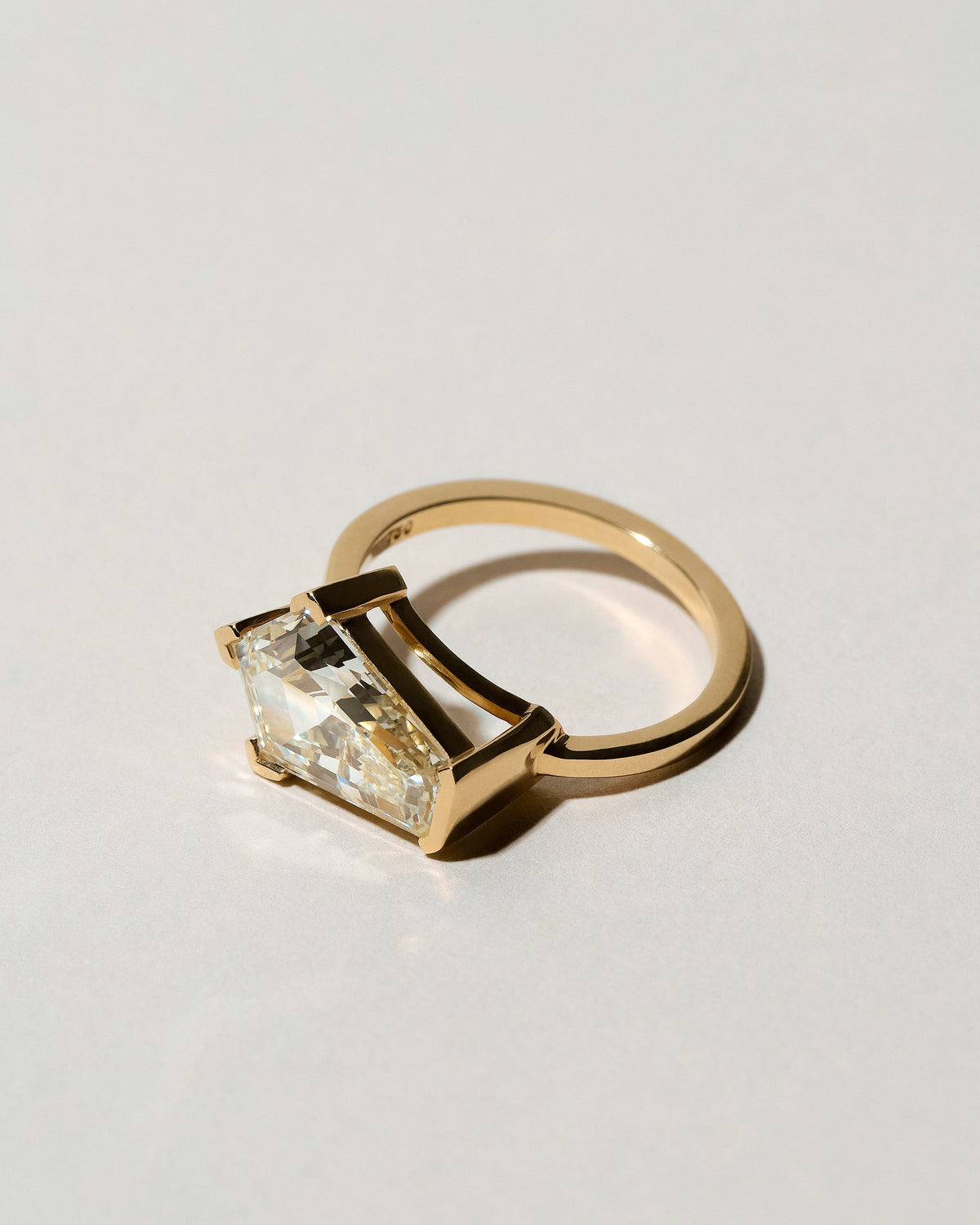 View from the side of the Modified Step Cut Diamond Ring on light color background.