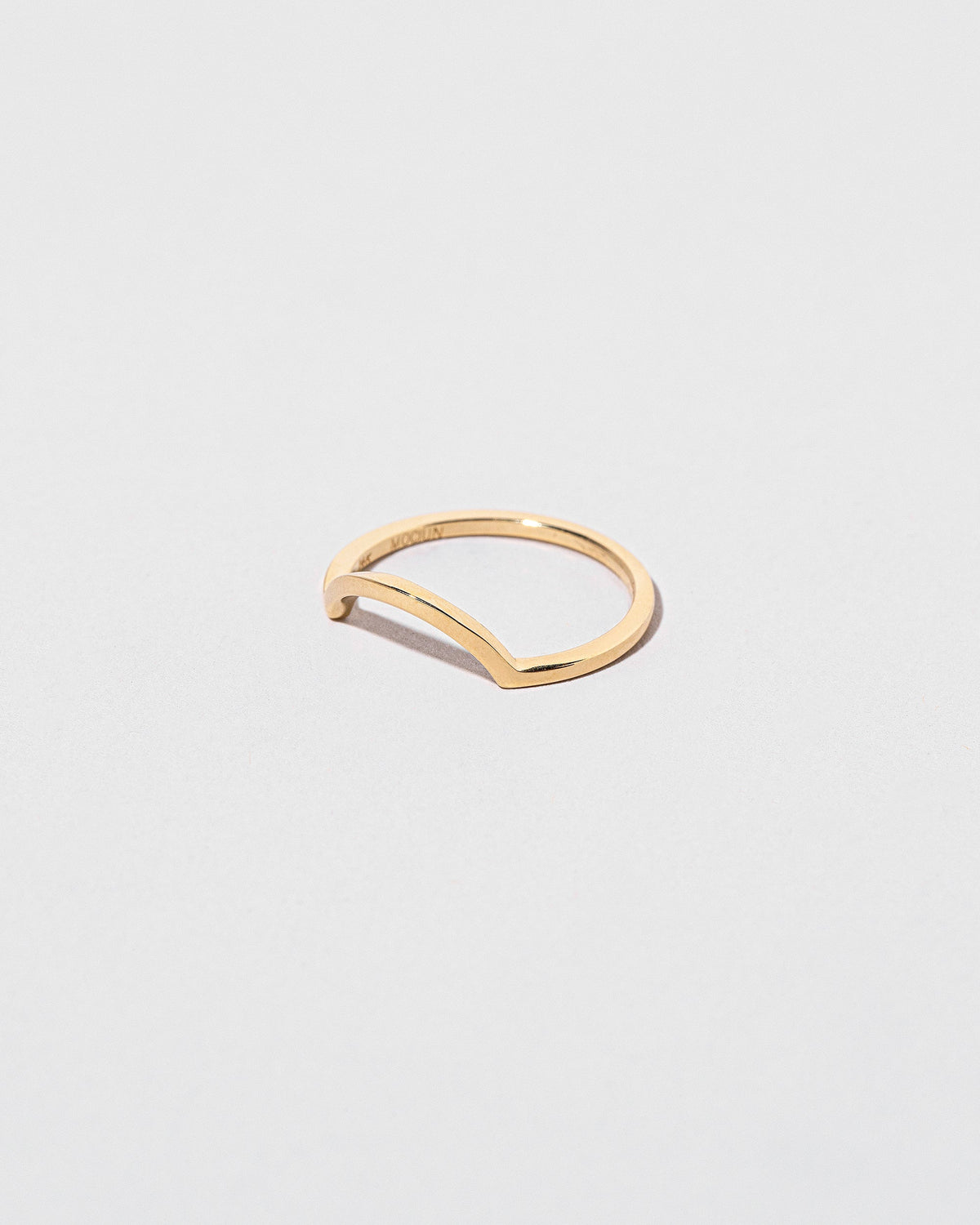 View from the side of the Gold Square Wire Curve Band on light color background.