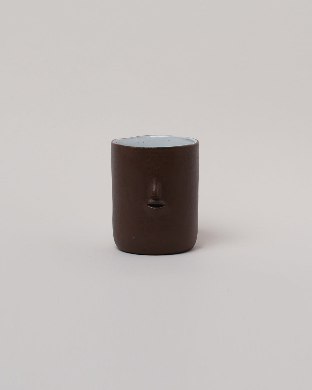 Rami Kim Chocolate Mini Face Tumbler on light color background.