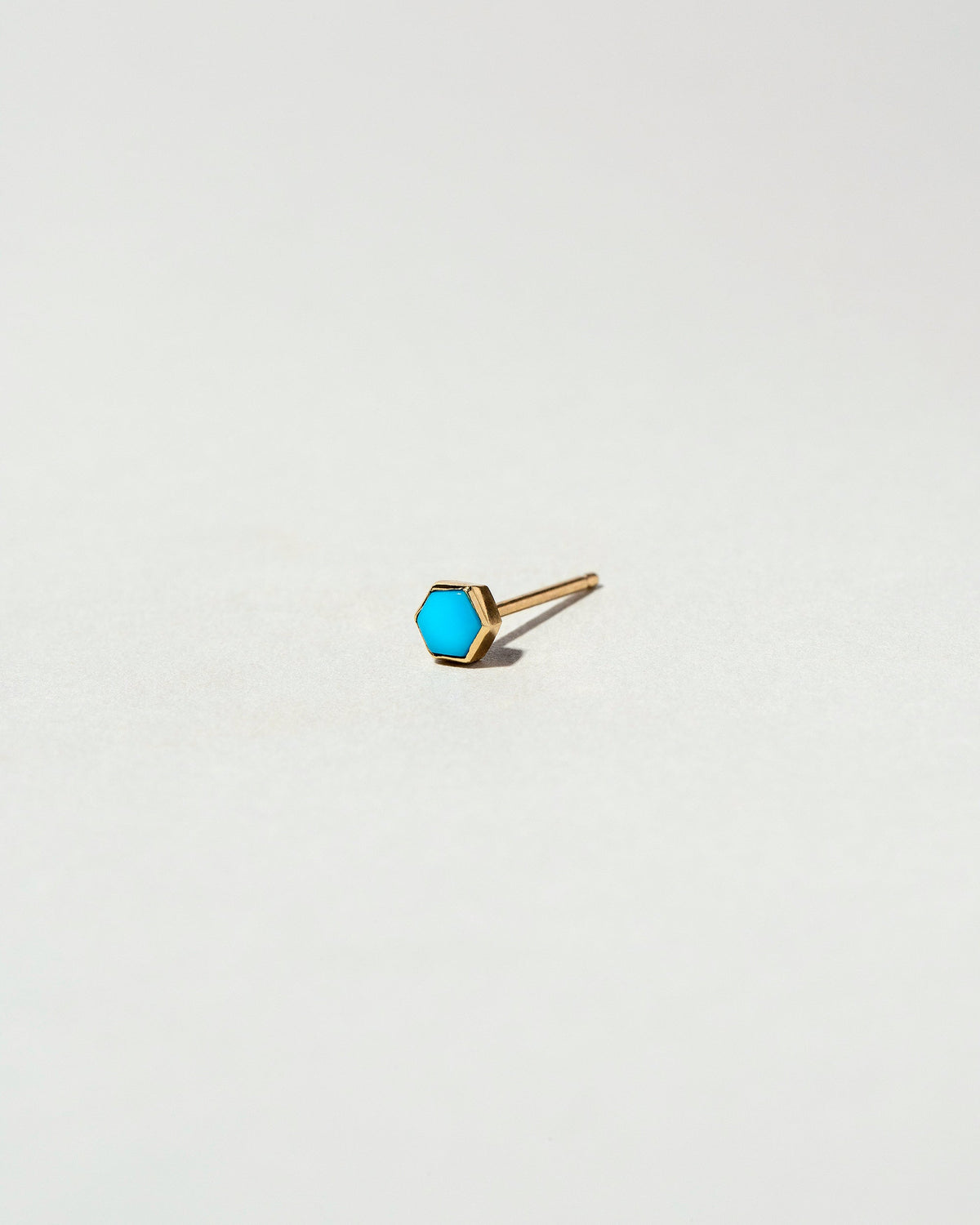 Turquoise Hexagon Stud Earring Single on light color background.