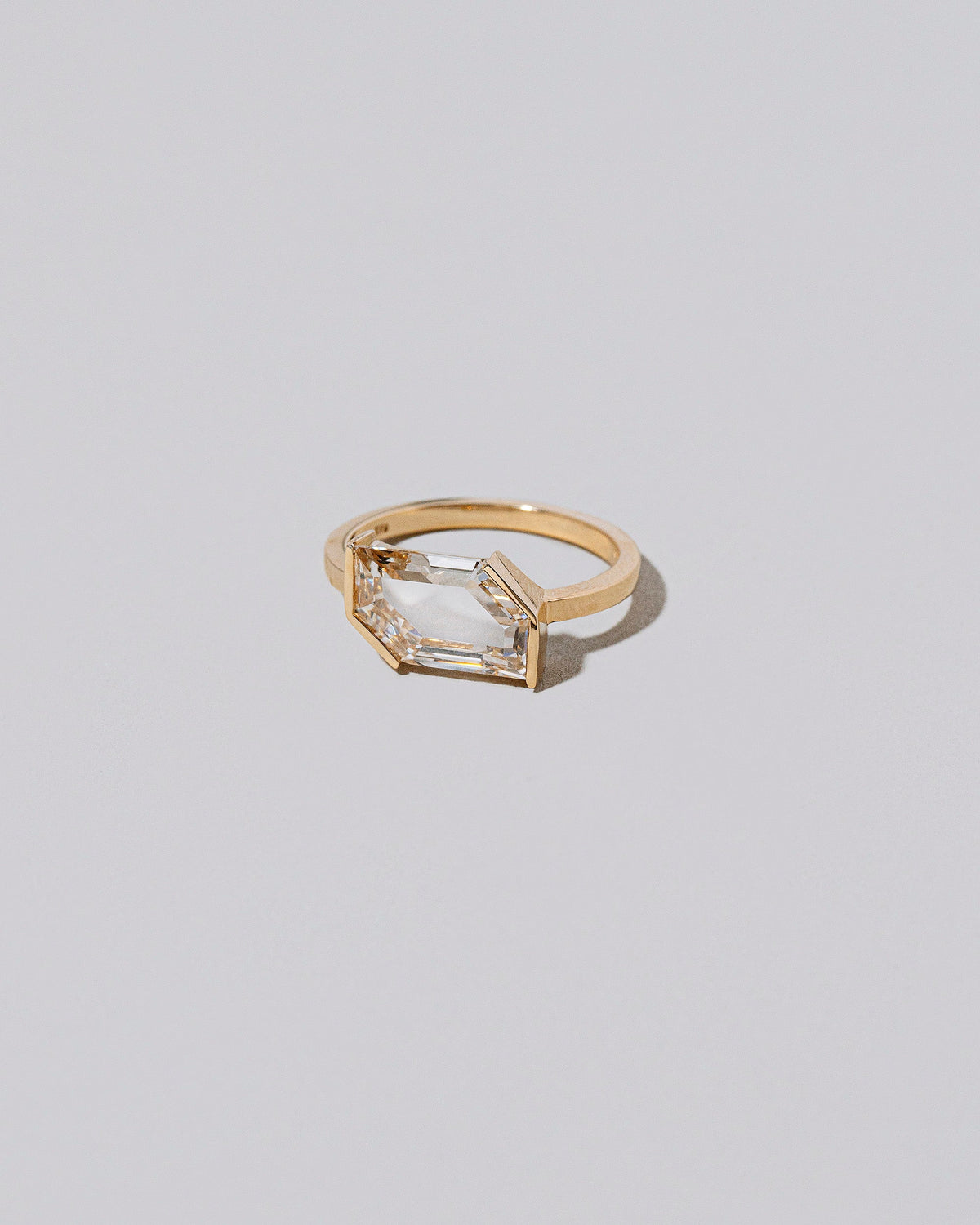 View from the side of the Heart & Soul Ring on light color background.