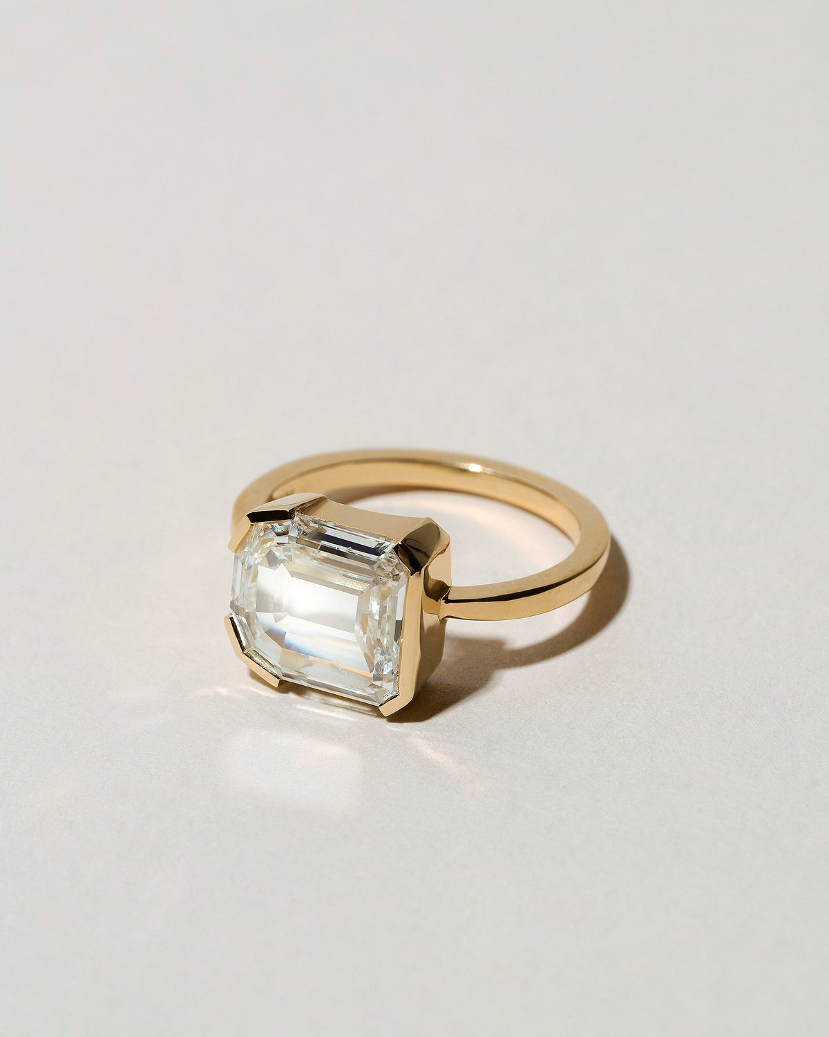 View from the side of the Shield Step Cut Diamond Ring on light color background.