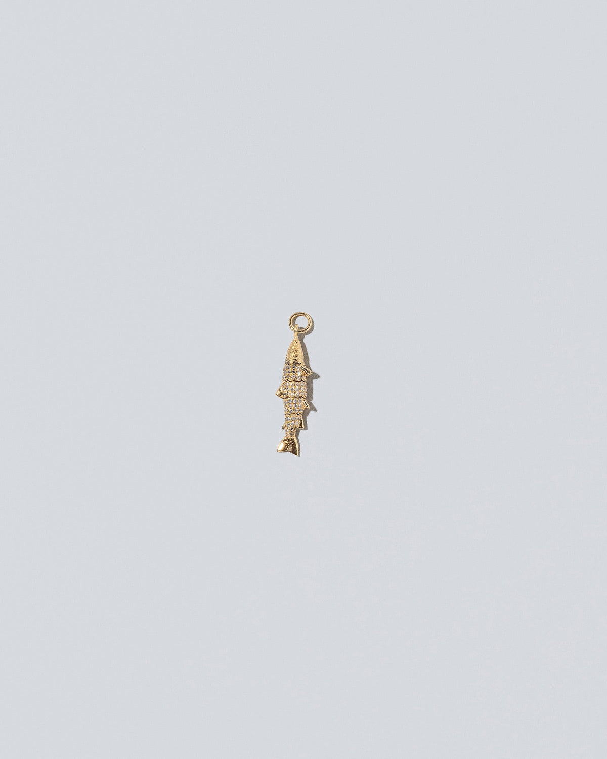 View from the back of the Pavé Fish Charm on light color background.