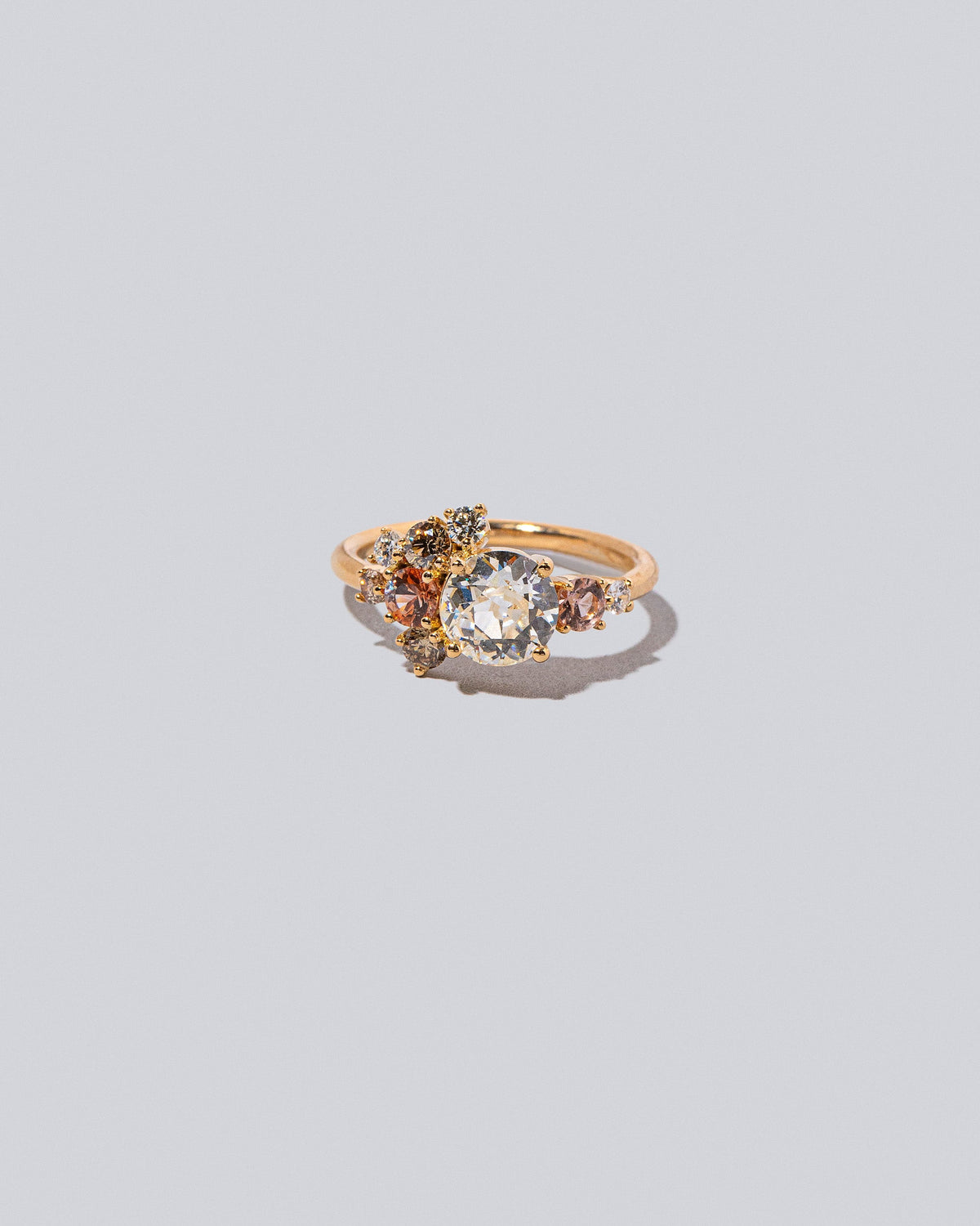 Product photo of the Peach Vega Ring on a light color background. 