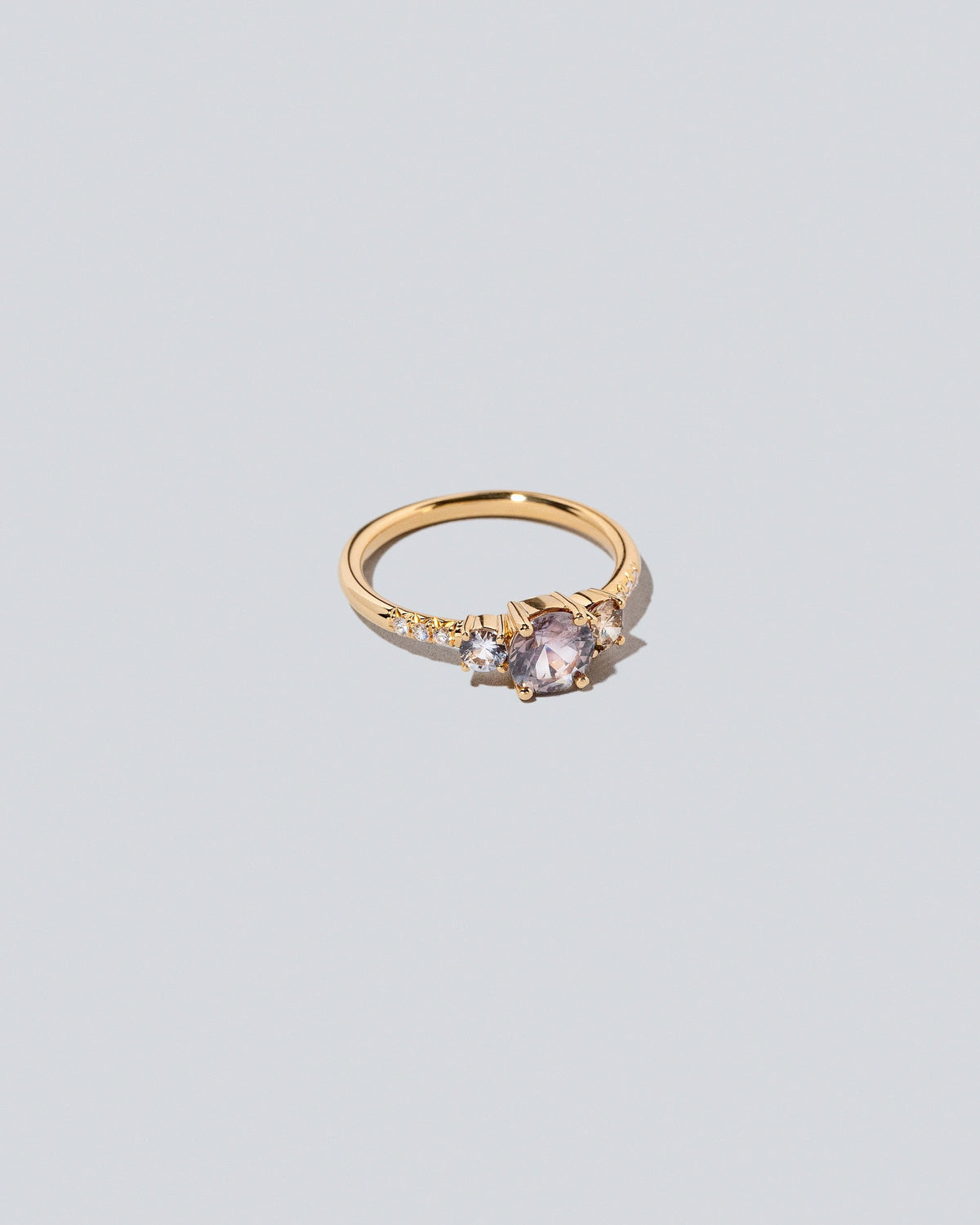 View from the side of the Purple Sapphire & Champagne Diamond Orion Ring on light color background.