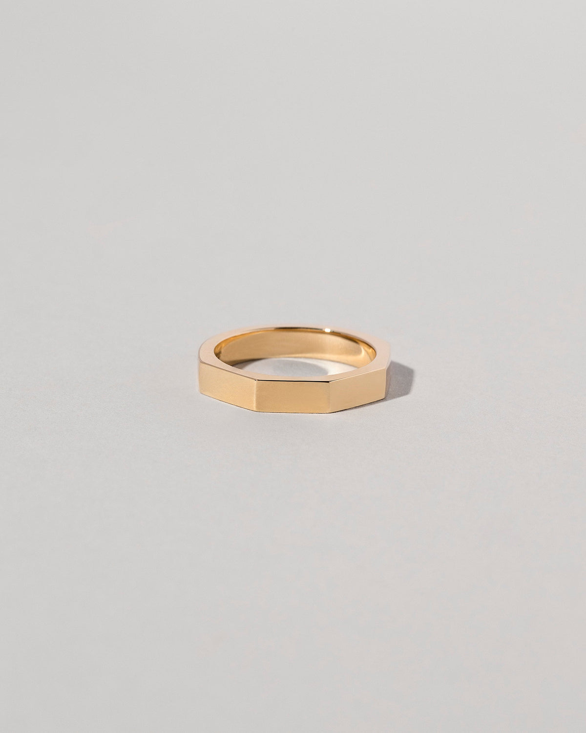 Gold 4mm Segmented Half Hoop Band on light color background.
