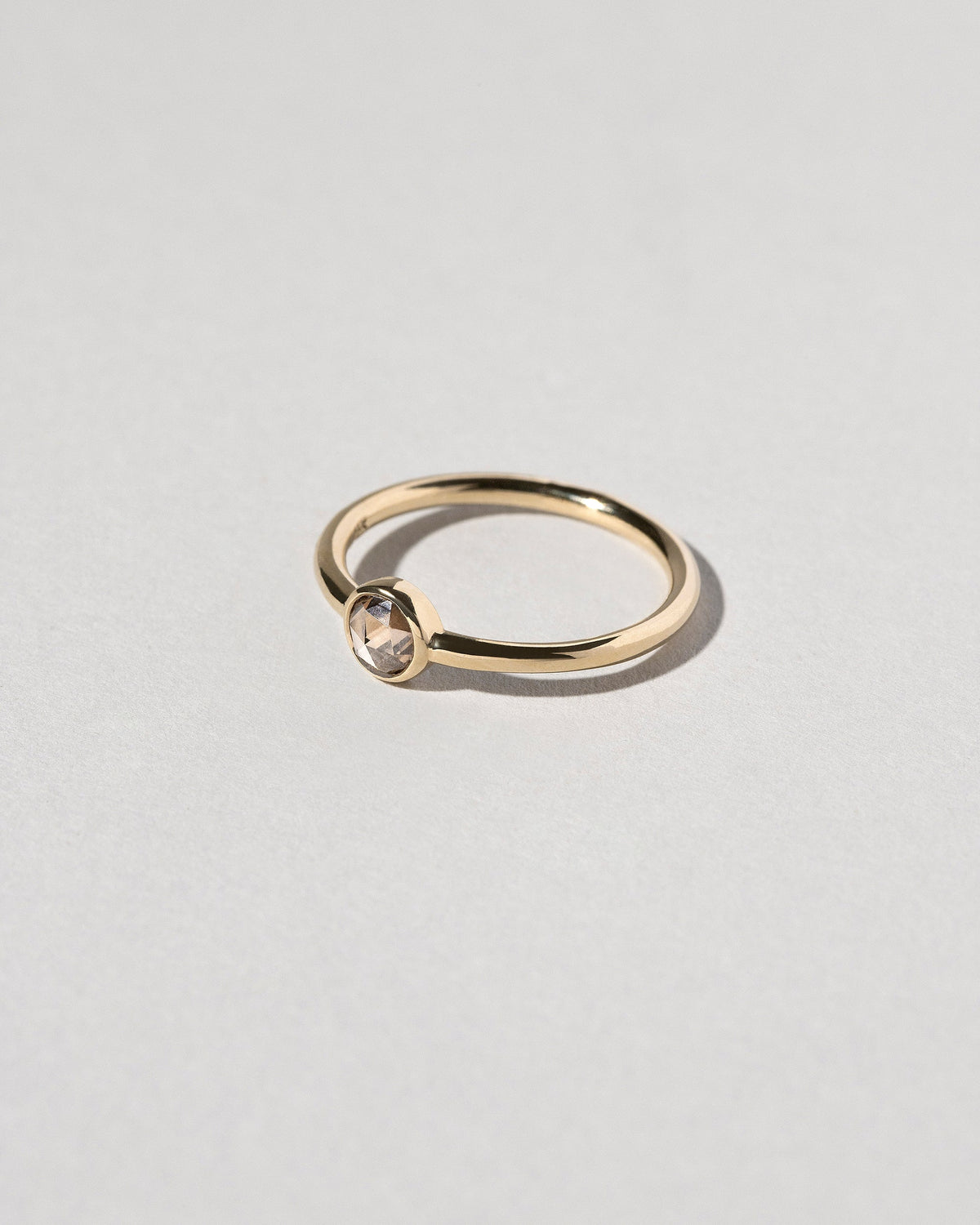 View from the side of the Rose Cut Champagne Diamond Ring on light color background.