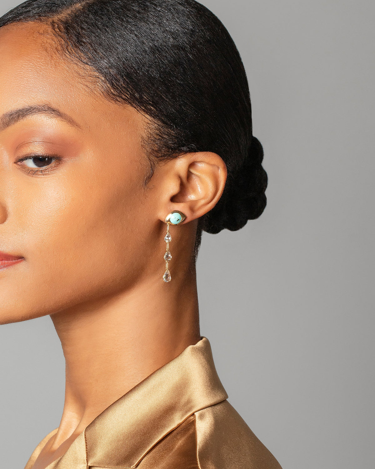 Turquoise Transformation Earrings on model.