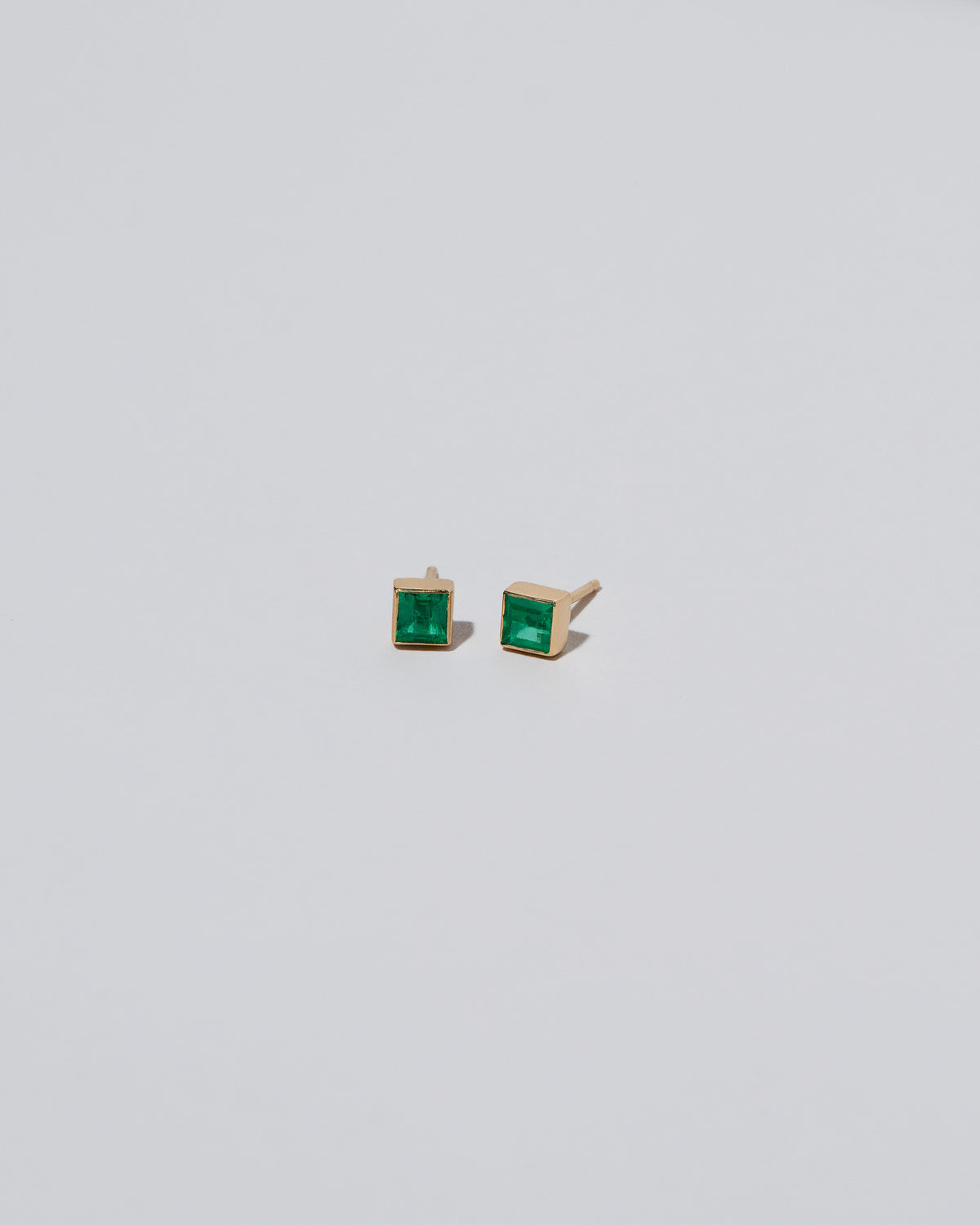 Square Stud - Emerald on light color background.