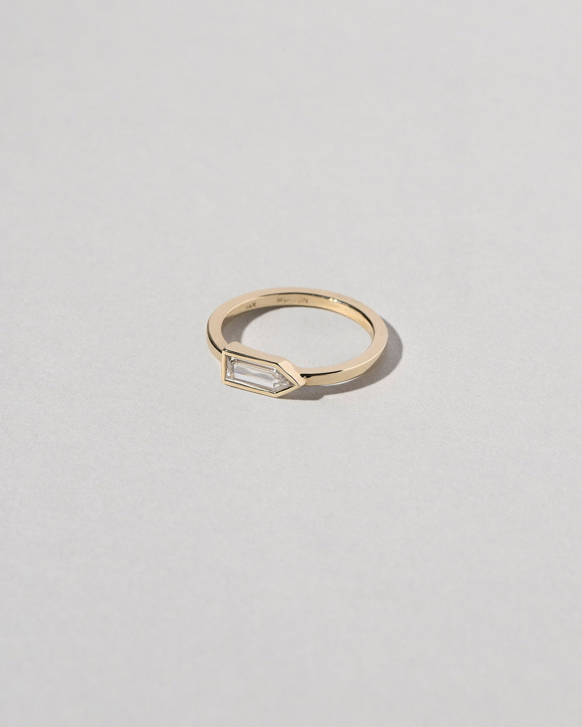 View from the side of the Bullet Cut Diamond Ring on light color background.