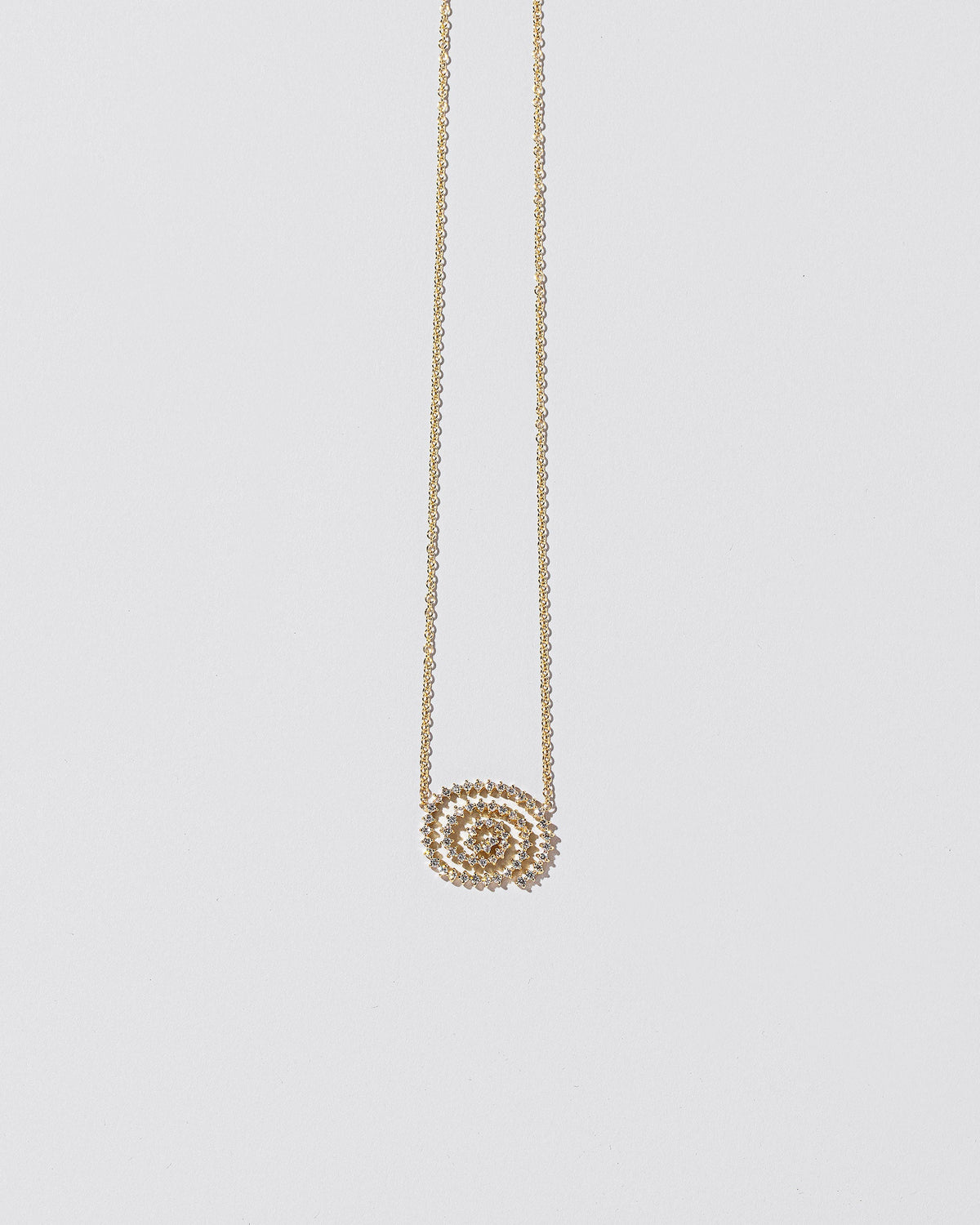 White Diamond Cycle of Rebirth Necklace on light color background.