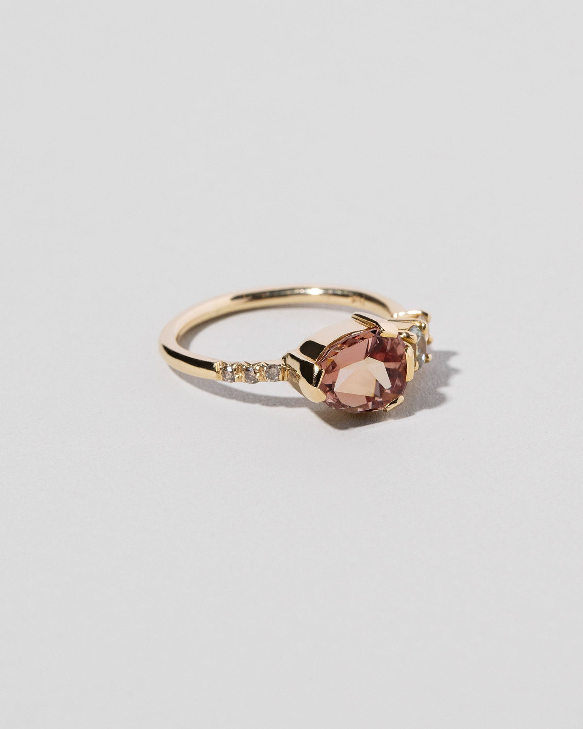 Garnet & Diamond Ring on light color background.