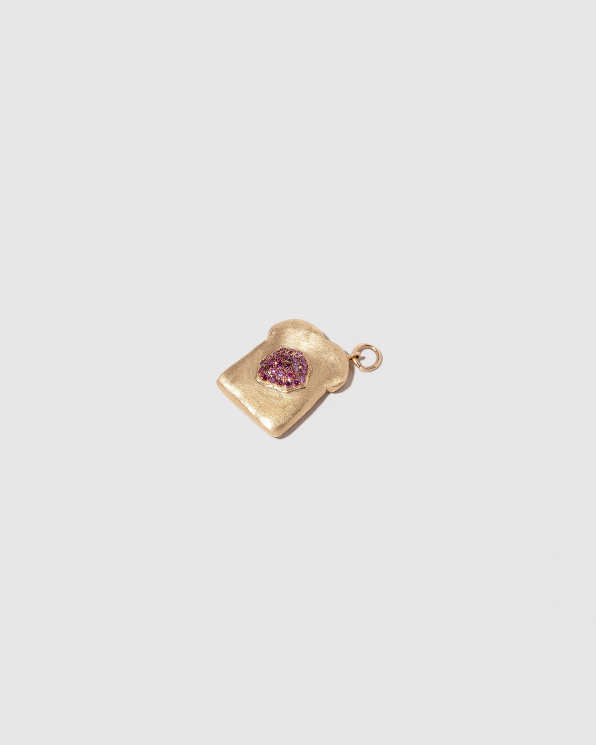 Closeup details of the Jelly Toast Charm on light color background.