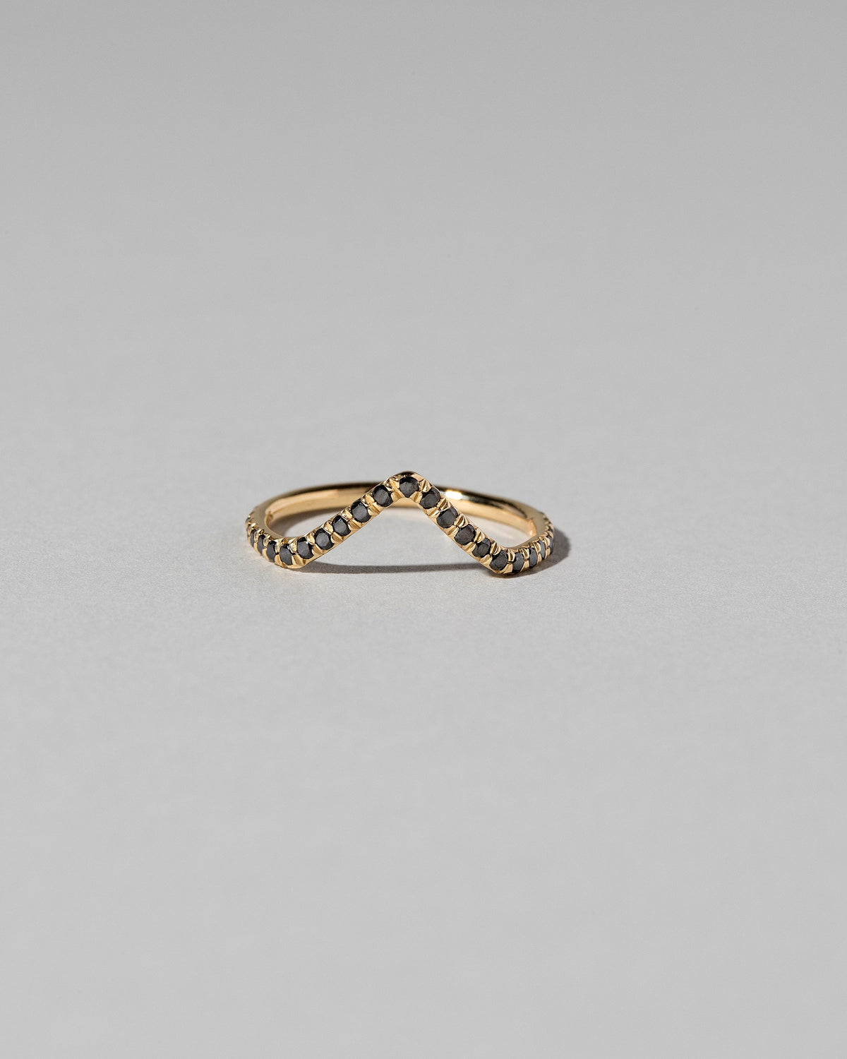 Gold Black Diamond Pavé High Peak Band on light color background.