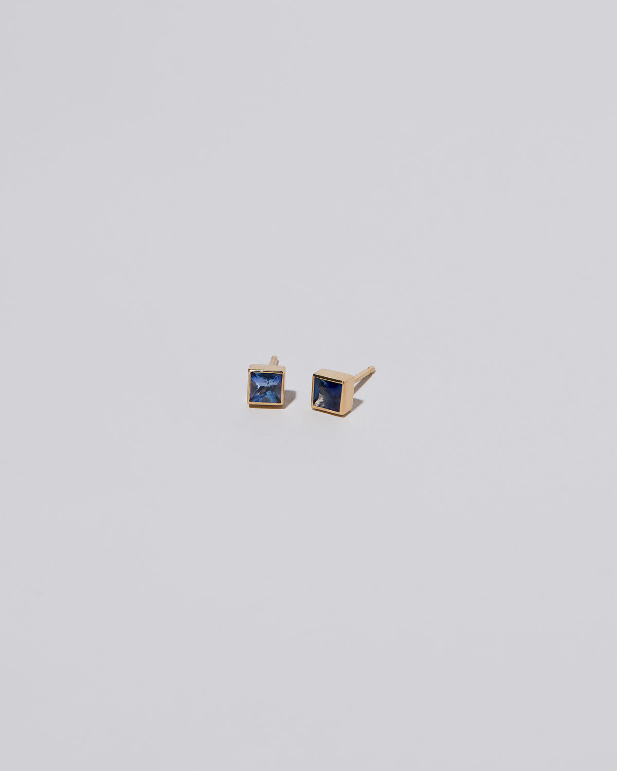 Square Stud - Blue Sapphire on light color background.