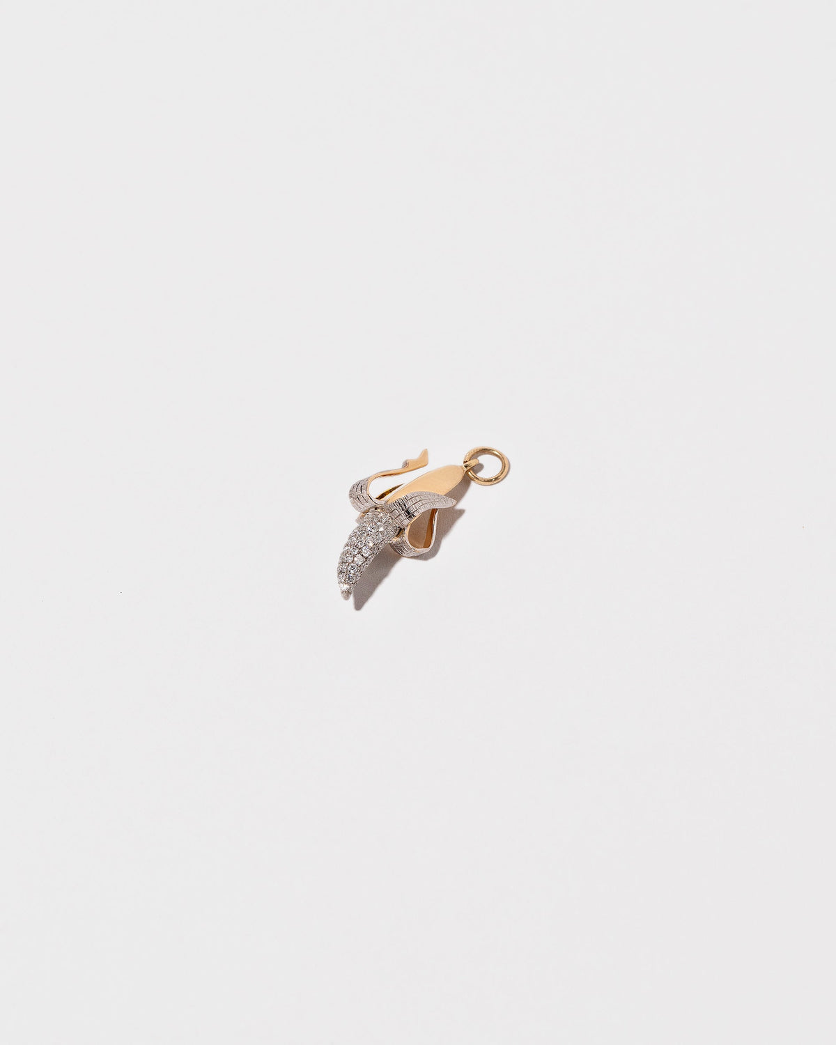 View from the side of the Peeled Banana Charm on light color background.