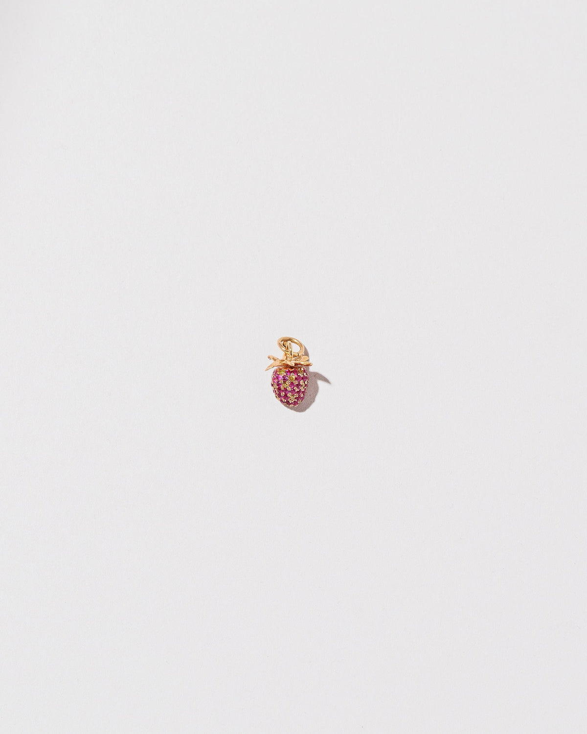 Diamond & Ruby Pavé Strawberry Charm on light color background.